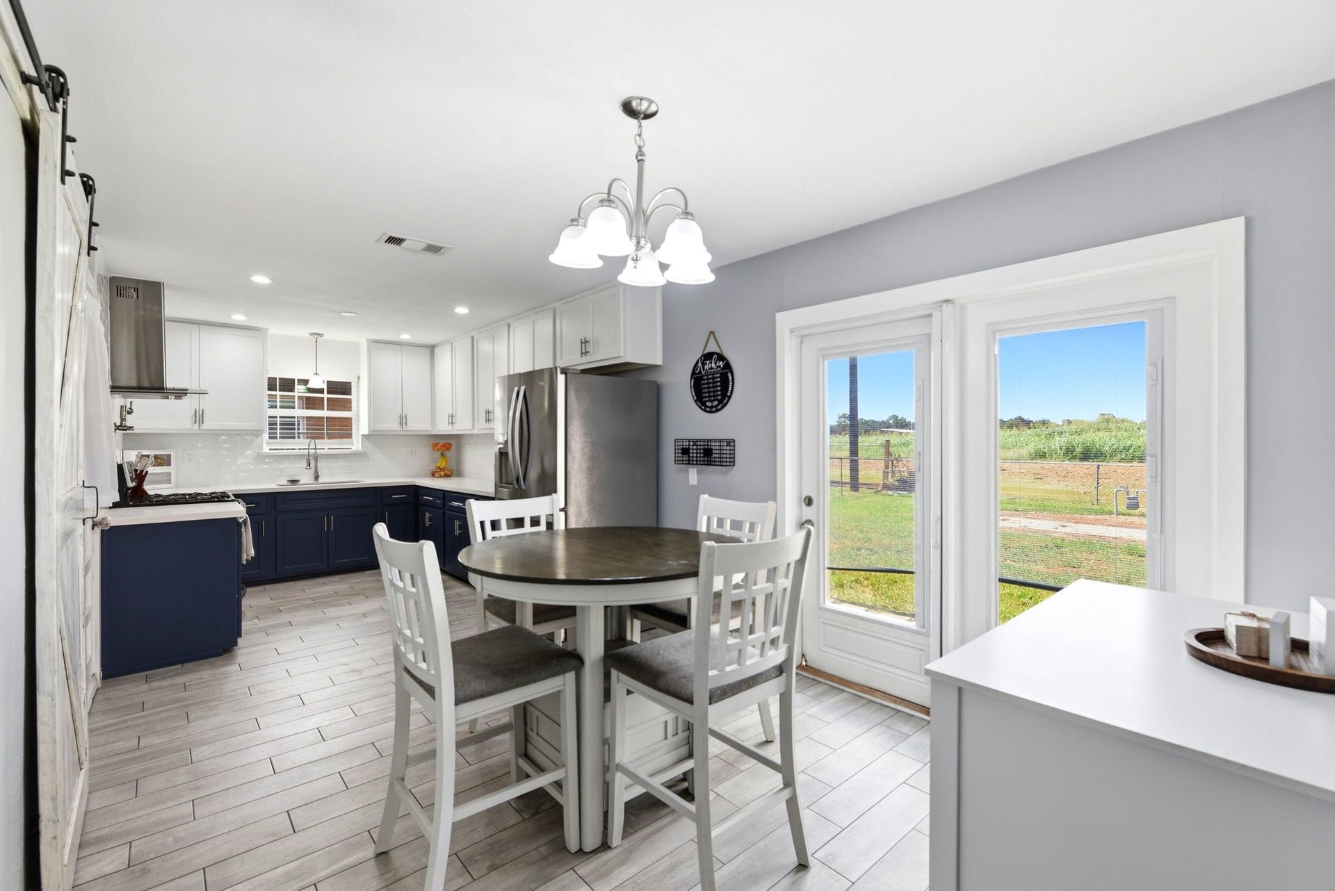 2405 Hillshire Drive, Deer Park, TX 77536 Bright and modern kitchen with sleek cabinetry, stainless steel appliances, and a cozy breakfast/dining area. Large windows and glass doors offer plenty of natural light and scenic views of the outdoors.