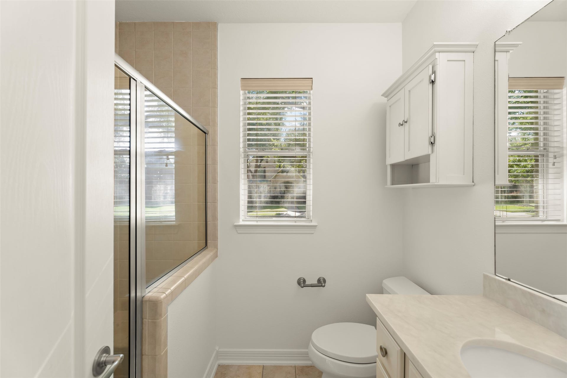 1211 Sterling Court, Katy, TX 77494 Bright and airy bathroom with a glass-enclosed shower and new quartz counter top.