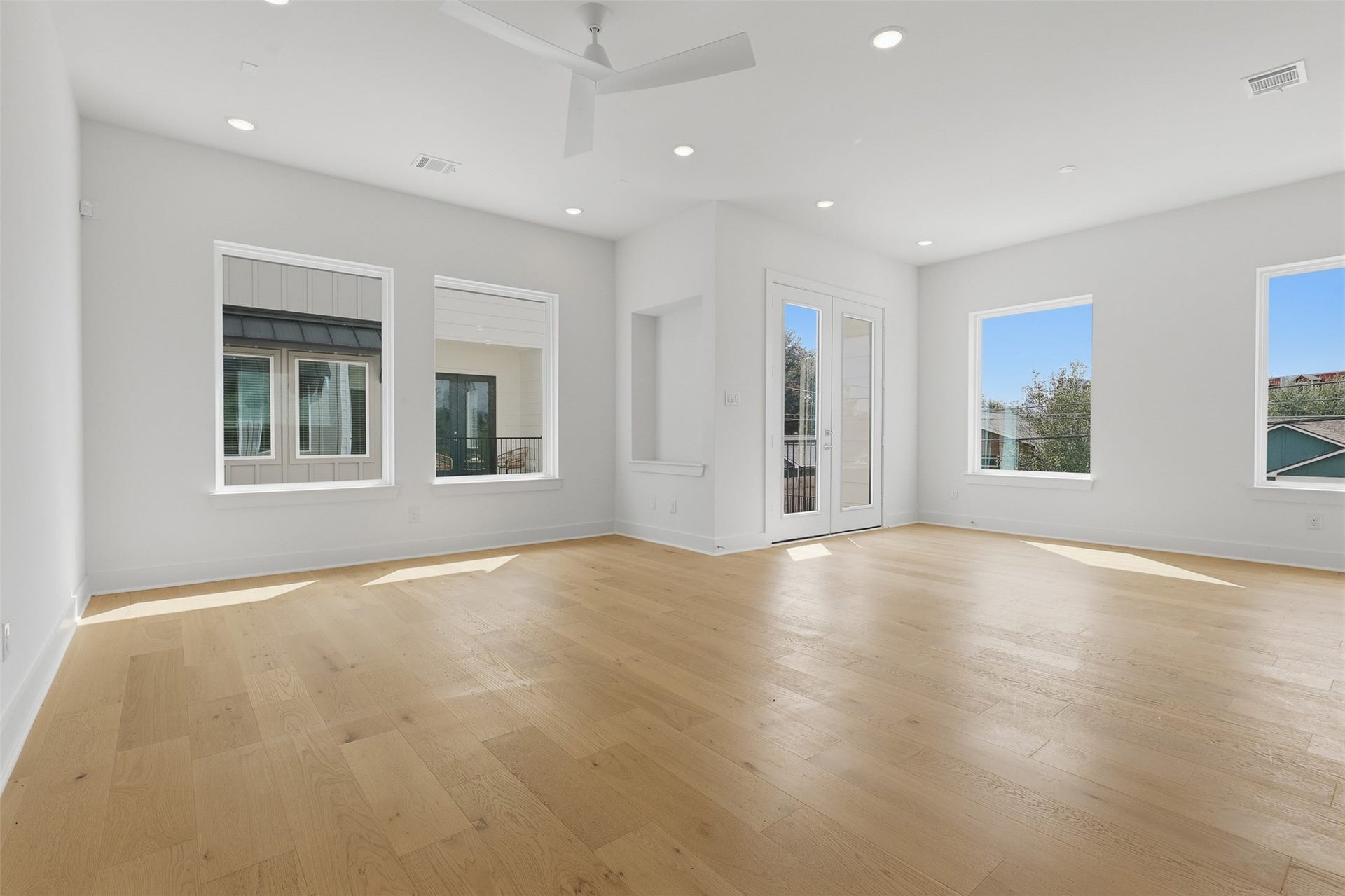 904 Kern Street, #C, Houston, TX 77009 Windows wrap around the living space, with a door leading outside.