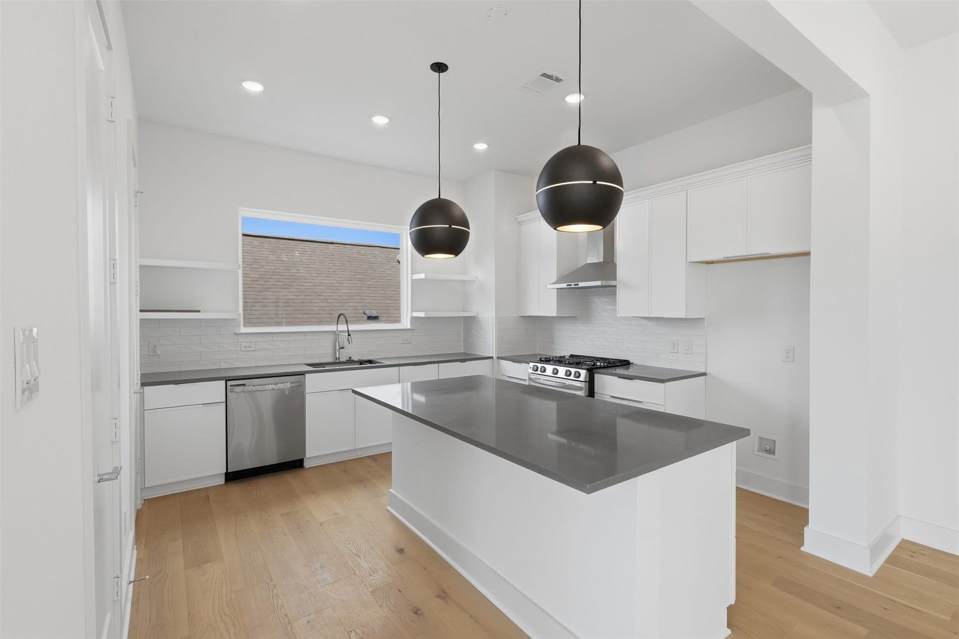 904 Kern Street, #C, Houston, TX 77009 The kitchen island creates a central place for meal preparation and gathering.