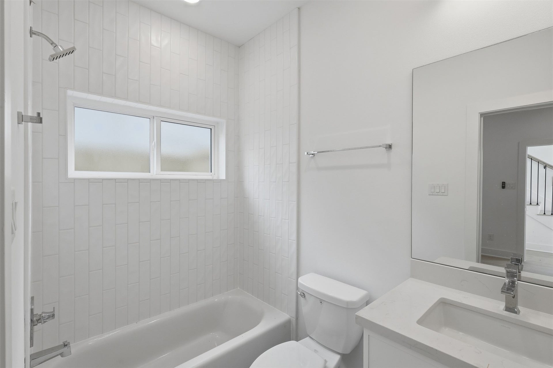 904 Kern Street, #C, Houston, TX 77009 This bathroom also includes a tub and shower combination, with a window above.