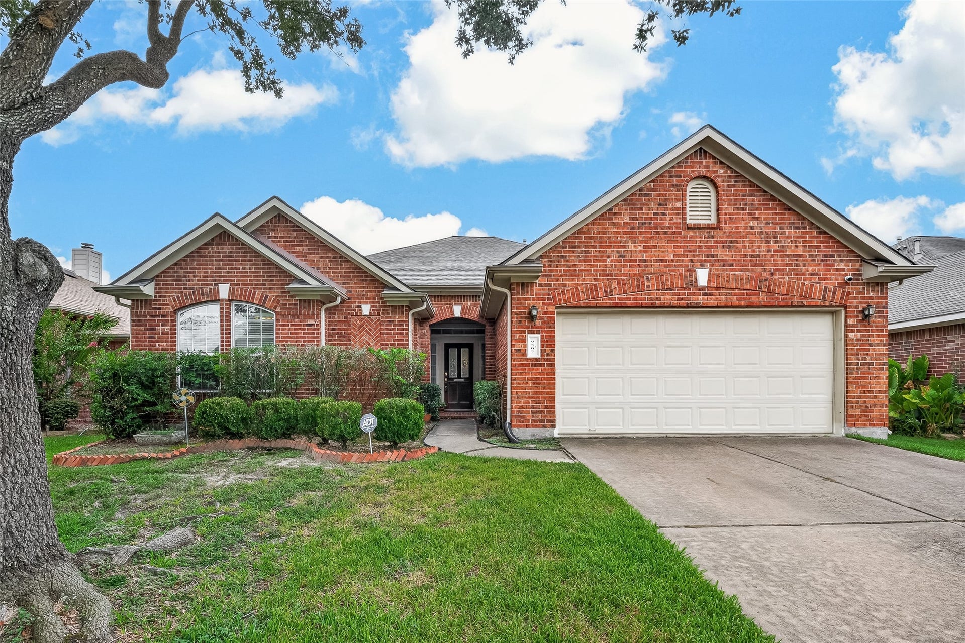 Charming brick home with a two-car garage, elegant gables, and well-maintained landscaping, offering great curb appeal in a serene neighborhood.