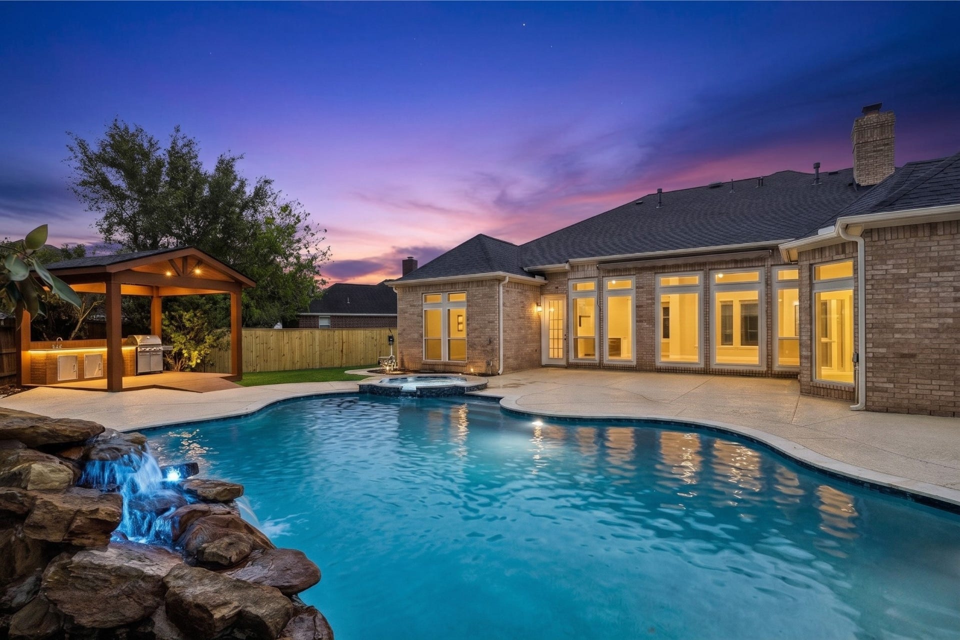 7503 NORTHWOODS DRIVE, Sugar Land, TX 77479 FULLY FENCED BACKYARD WITH POOL, COVERED OUTDOOR KITCHEN AREA, AND GENEROUS SPACE FOR YEAR-ROUND ENJOYMENT.