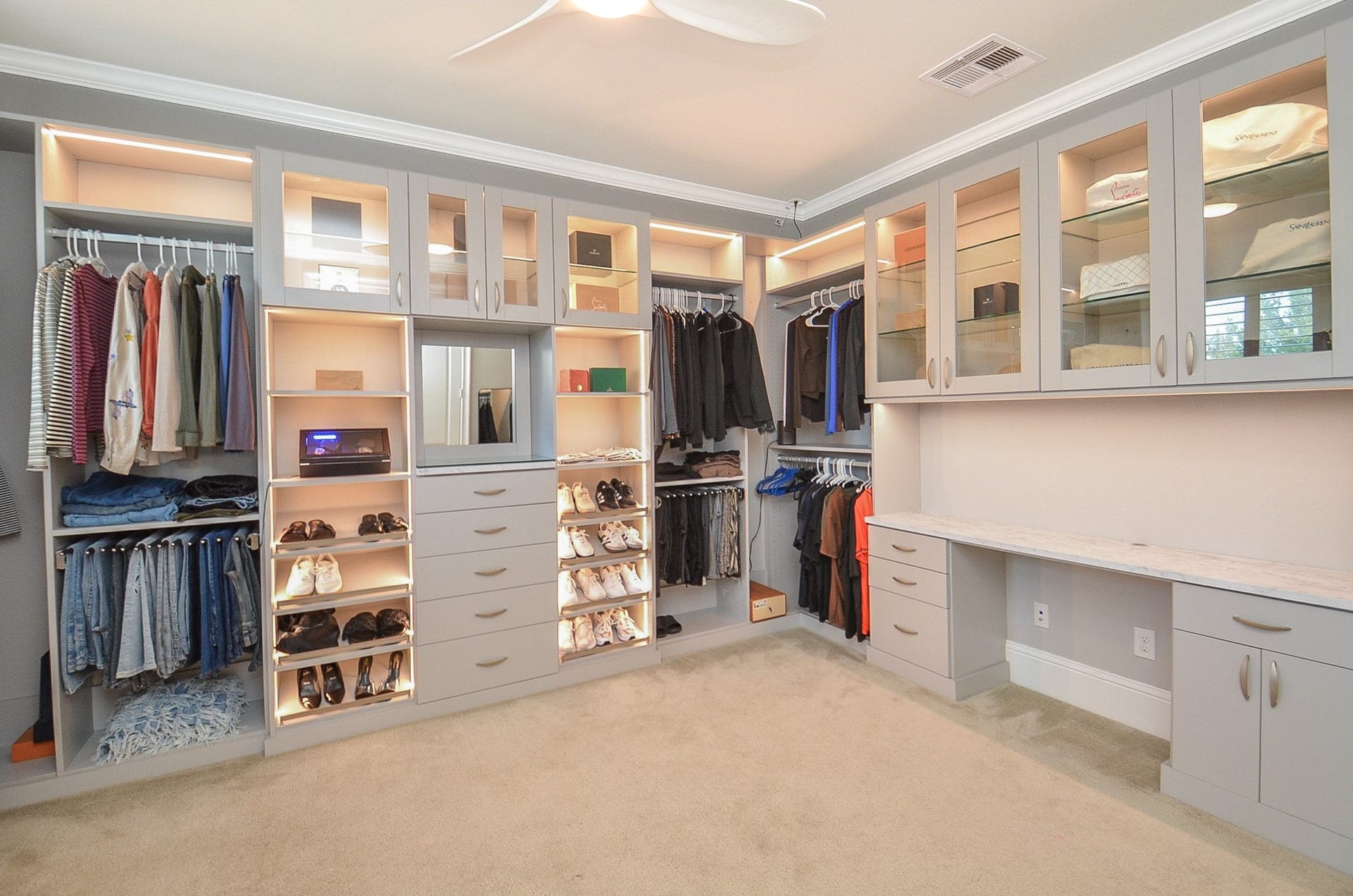 This bedroom was transformed into a custom closet with built ins ans lighting.