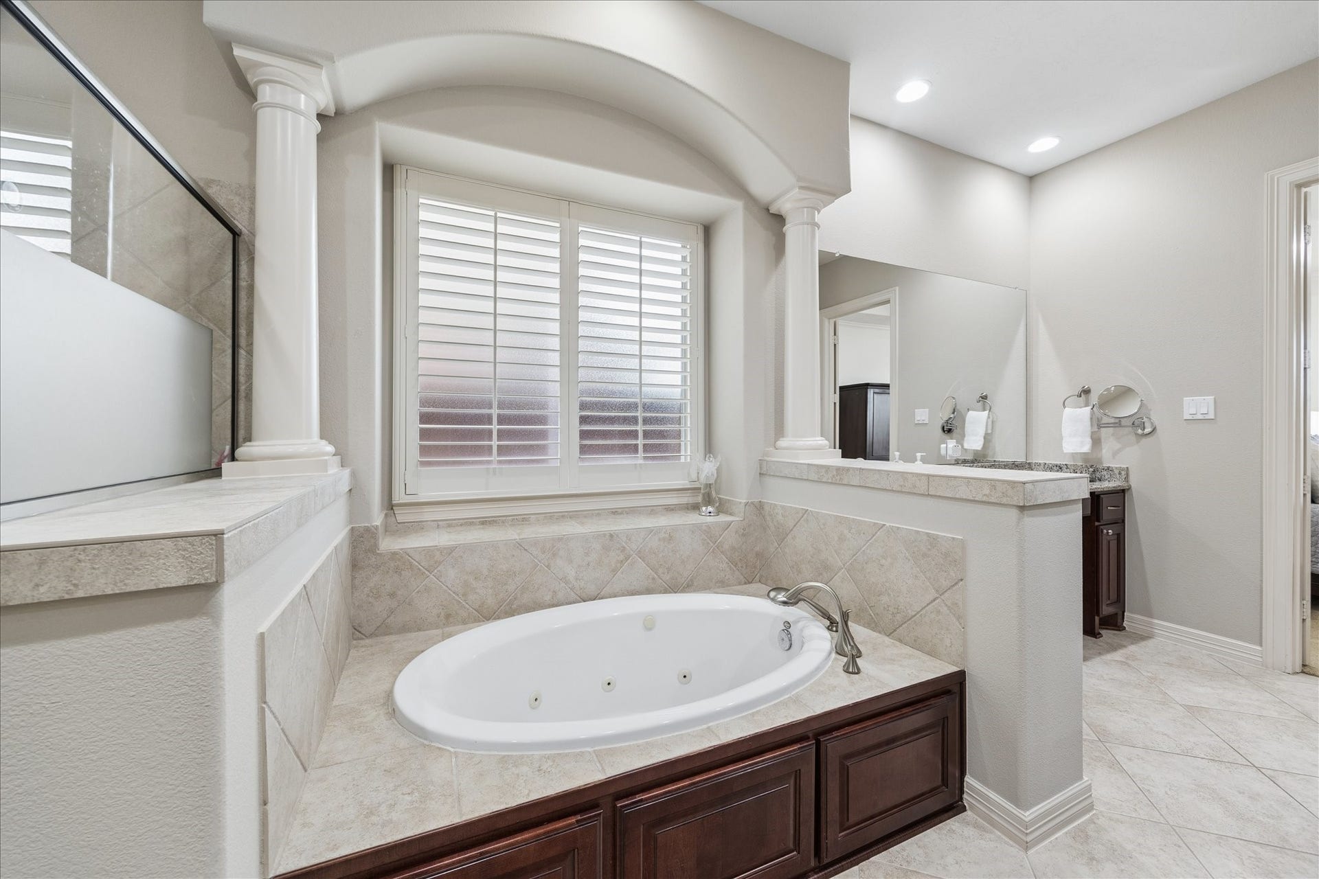 The en suite bath features separate jetted tub in a cozy nook.