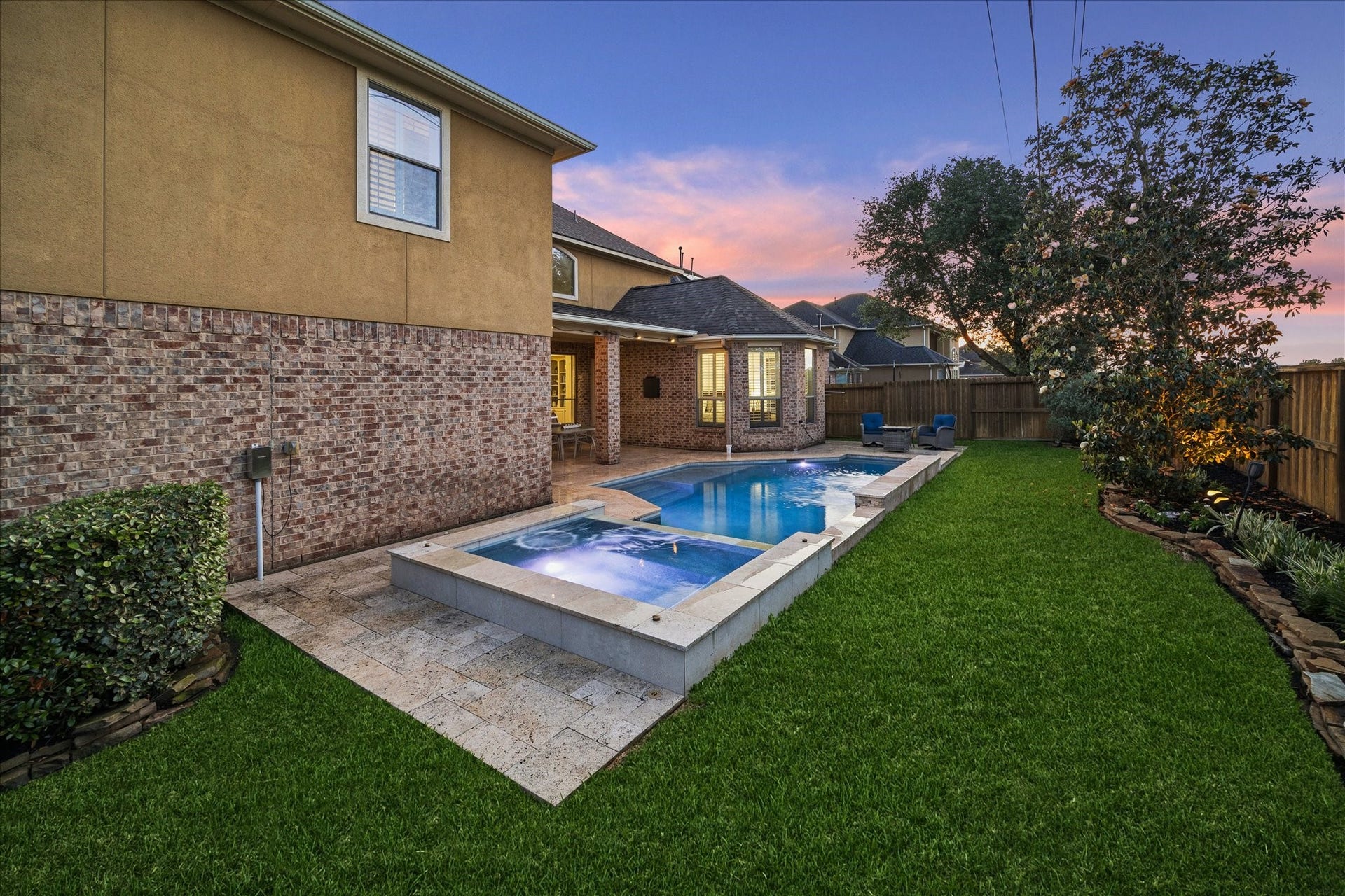 The pool is perfectly situated off of the covered patio.