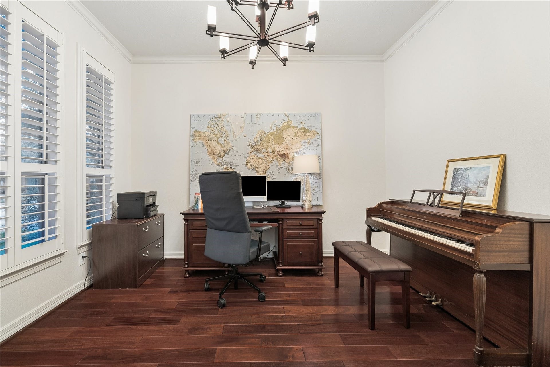 A home office space is tucked into a quiet corner just off the entry.