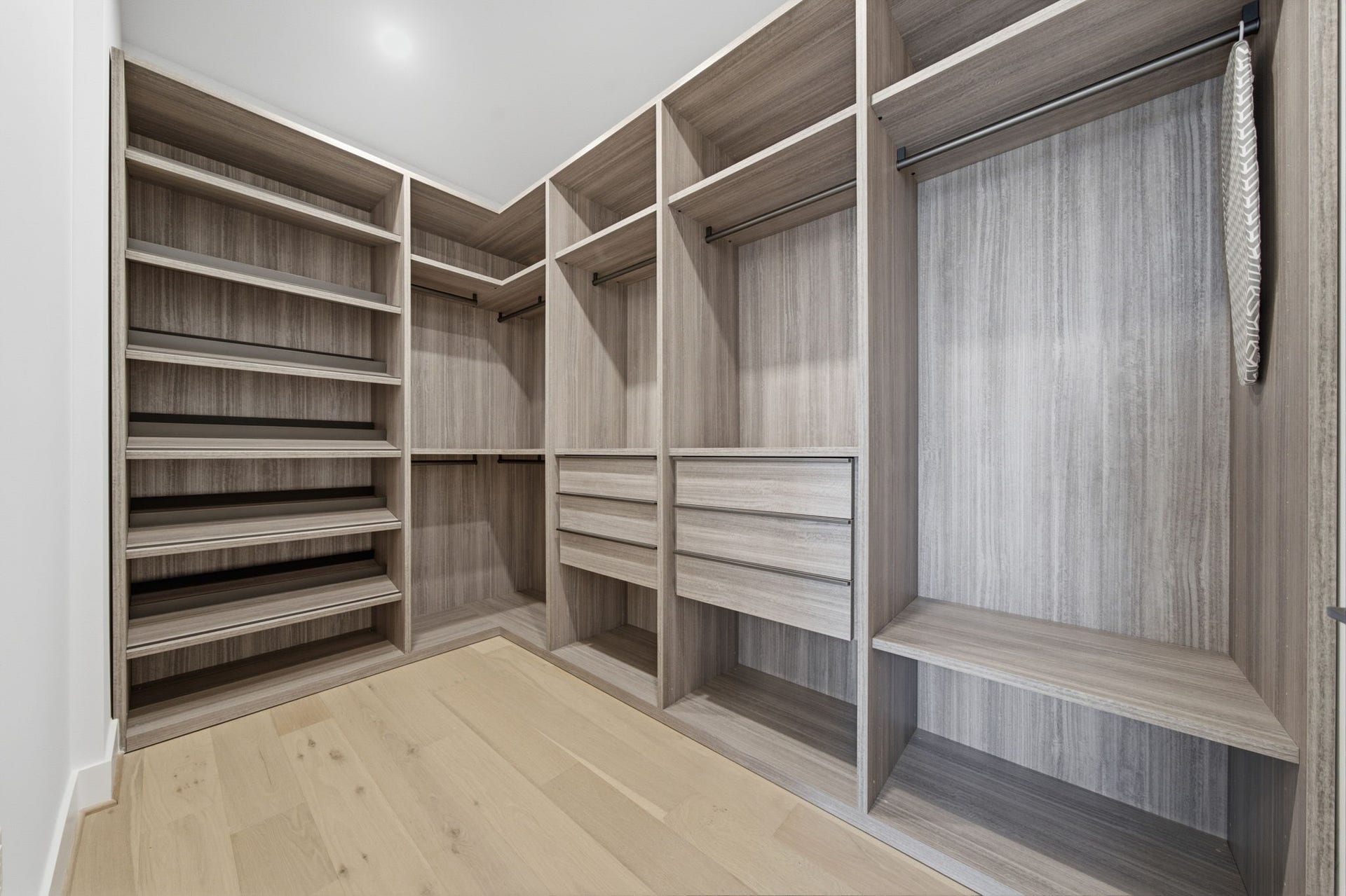 A custom walk in wardrobe with exceptional scale and organization elevates the daily routine.