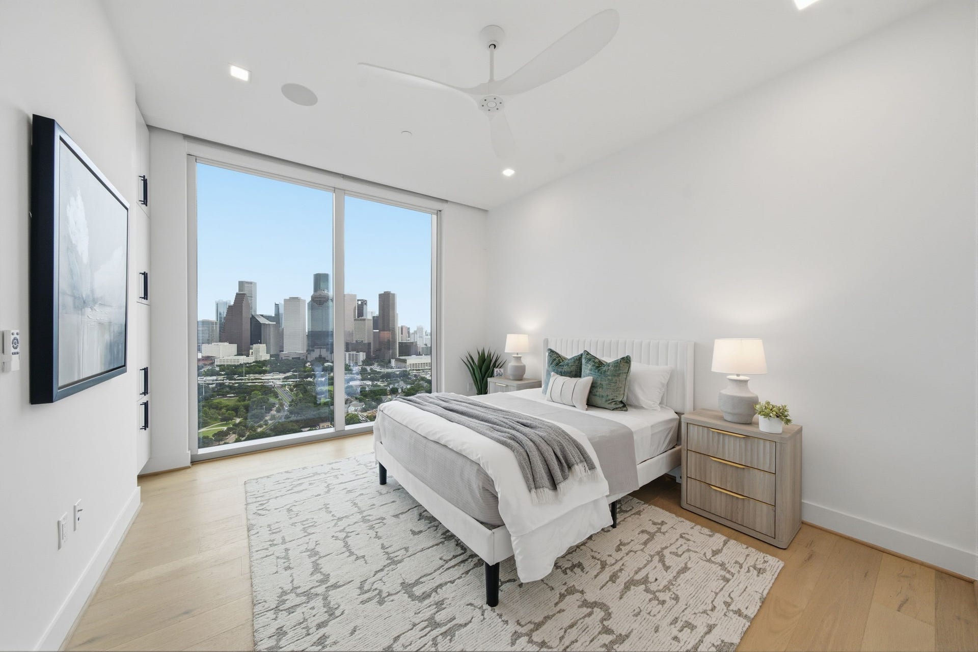 A private guest retreat featuring floor to ceiling windows with breathtaking Downtown Houston views, custom motorized blinds, and additional built in storage cabinetry. Thoughtfully designed to provide comfort, convenience, and an elevated luxury living experience for family and guests.