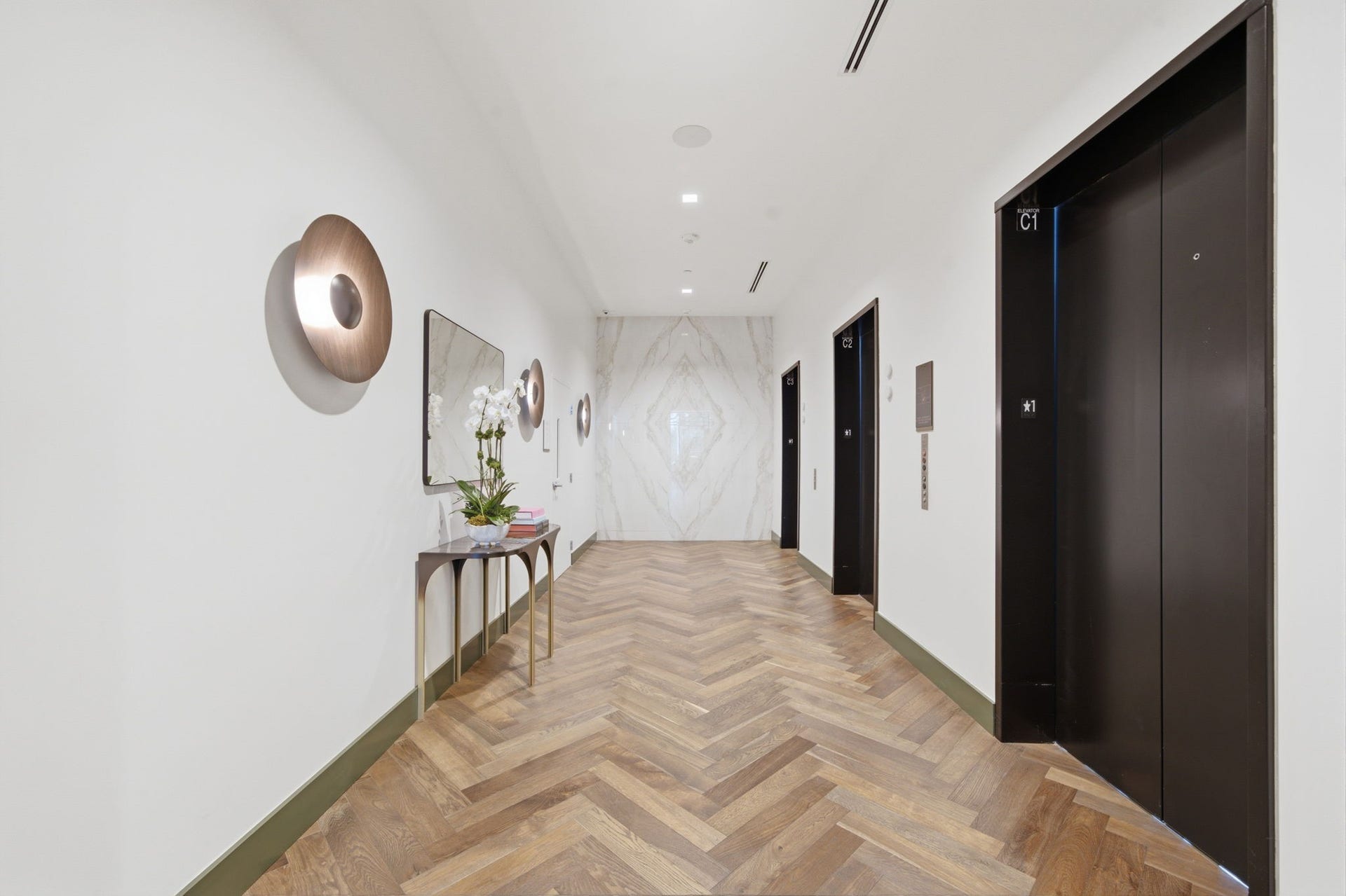 Aprivate arrival experience begins with elegant corridors, refined finishes, and the exclusivity of high rise living.