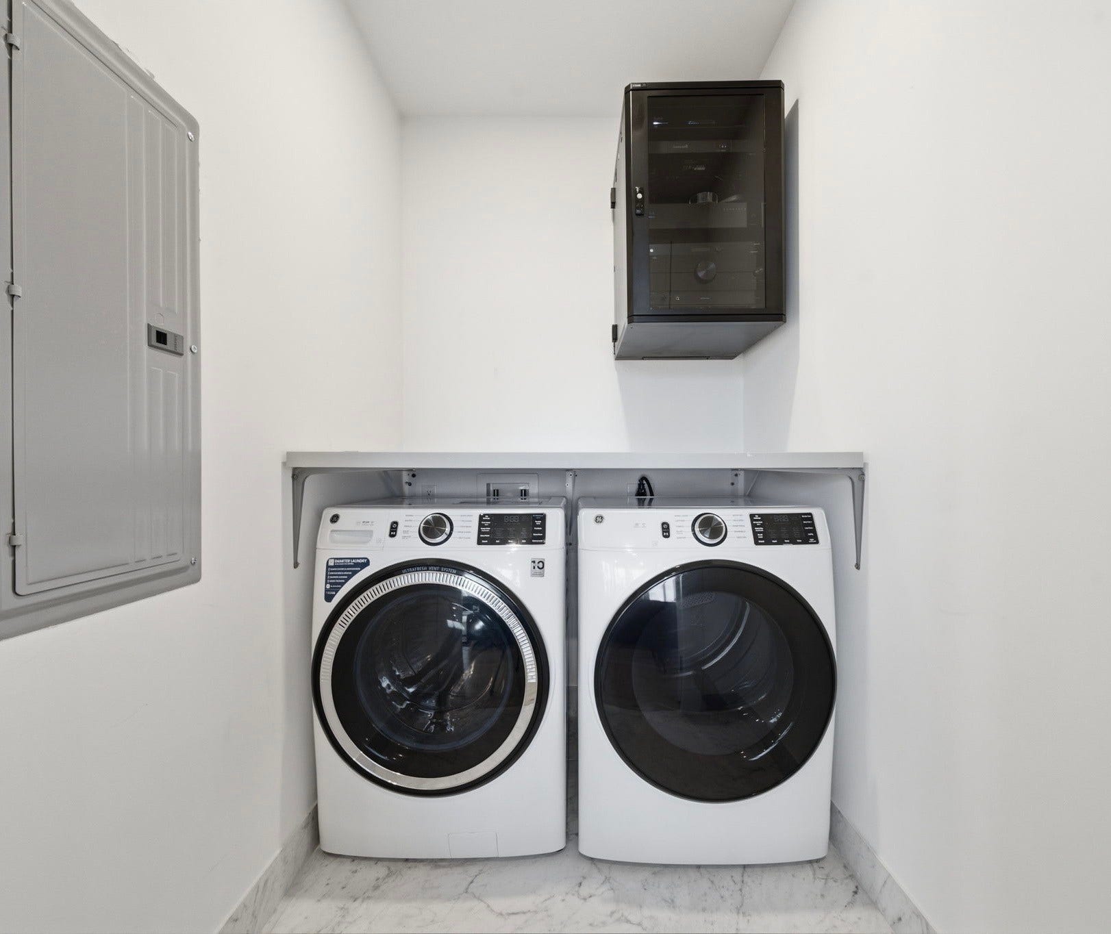 Full size laundry room with premium washer, dryer, and concealed media equipment.