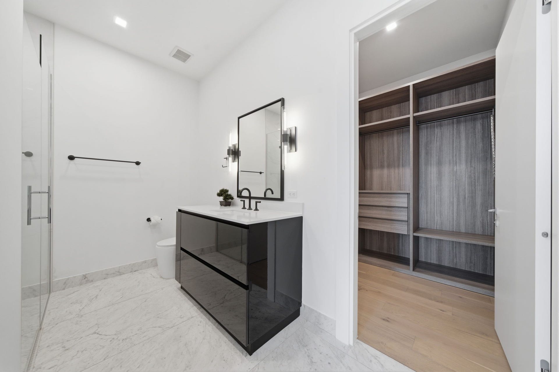 The secondary bath combines timeless design with premium finishes, featuring an oversized glass enclosed shower, elegant Delta fixtures, and a refined spa inspired atmosphere that ensures guests enjoy the same level of luxury found throughout the residence.