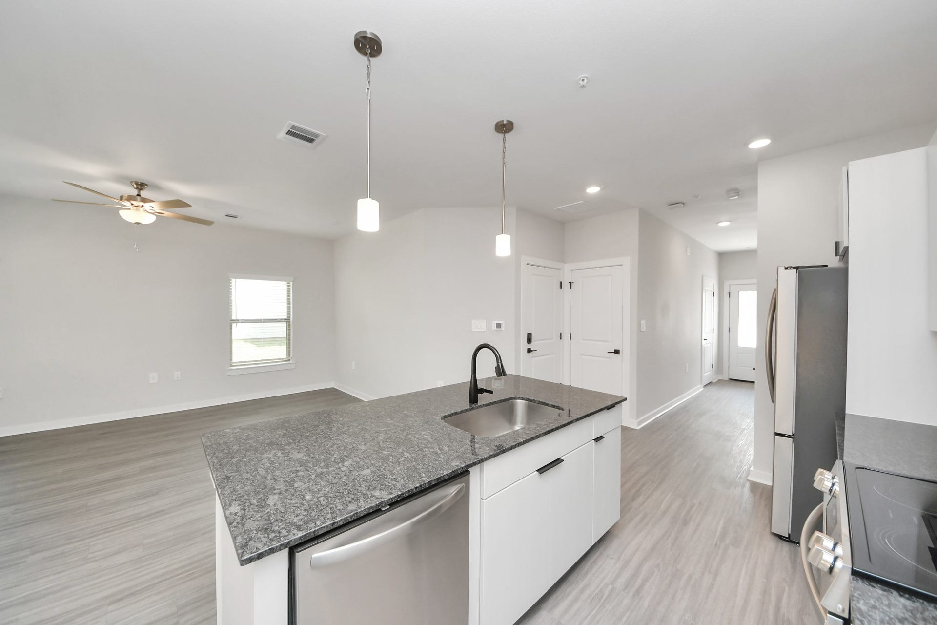 7711 Longmire Road, #199, Conroe, TX 77304 Boasting luxury finishes-stylish Island kitchen,granite counters,subway tile backsplash,ample custom cabinet space,stainless appliances,refrigerator,full size washer&dryer included,wood-like floors throughout,open concept floor plan.