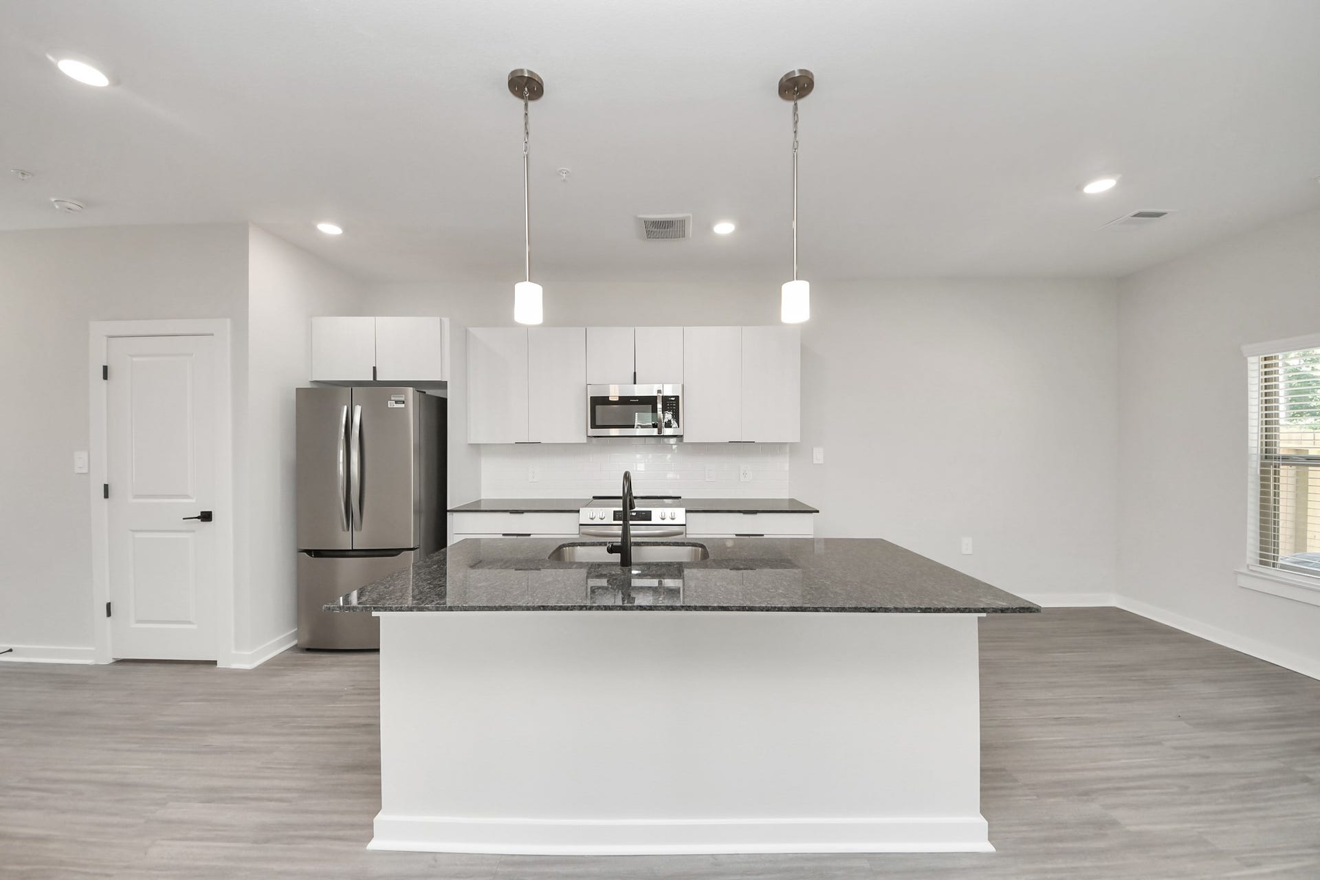 7711 Longmire Road, #199, Conroe, TX 77304 Boasting luxury finishes-stylish Island kitchen,granite counters,subway tile backsplash,ample custom cabinet space,stainless appliances,refrigerator,full size washer&dryer included,wood-like floors throughout,open concept floor plan.