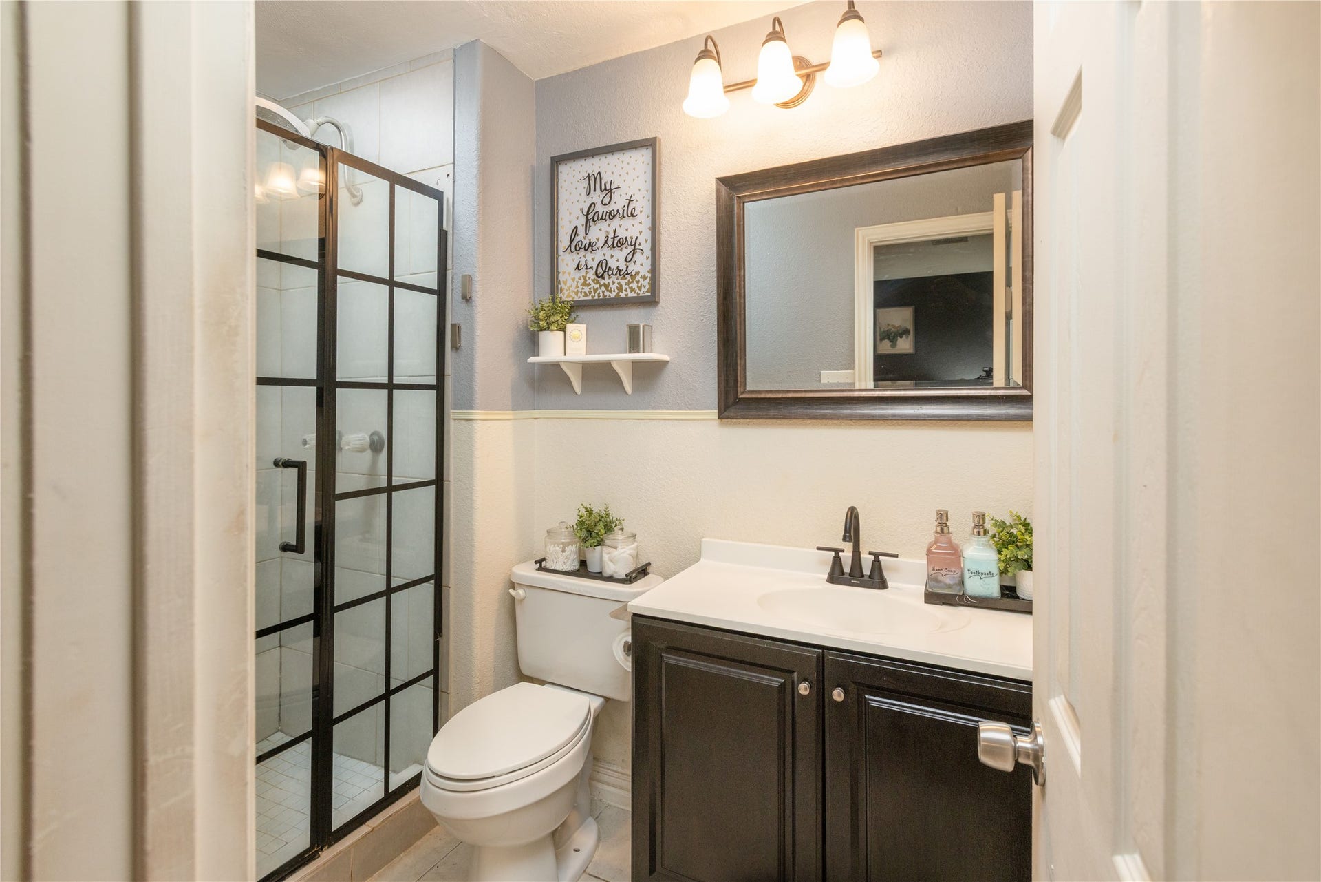 14007 Lorne Drive, Houston, TX 77049 Chic bathroom with a modern glass-enclosed shower, elegant vanity, and stylish lighting, offering a fresh and inviting space.