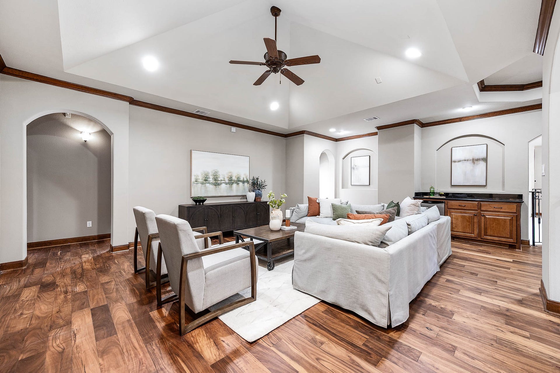 The upstairs game room features new hardwood floors, a tray ceiling, and built-in cabinetry.