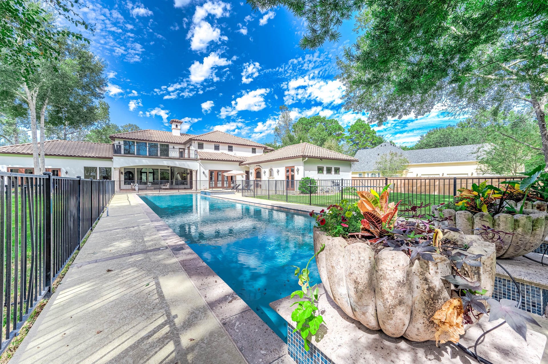 Looking back toward the home, the fully fenced backyard is enclosed by a new premium tall cedar fence.