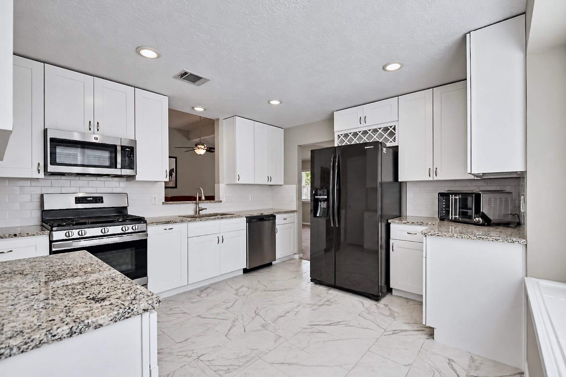 2419 Broken Elm Drive, Richmond, TX 77406 The remodeled kitchen delivers more than good looks, with abundant cabinetry, granite work surfaces and storage positioned where everyday cooking actually needs it.