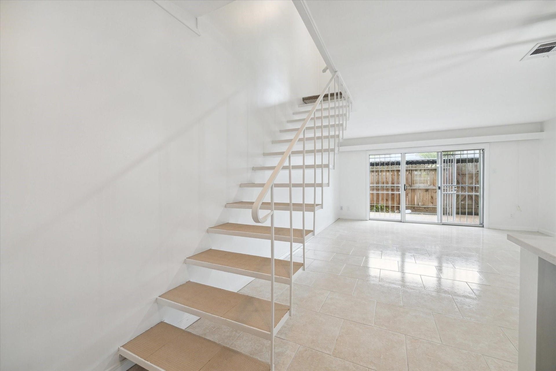 7821 Rue Saint Cyr Street, #55, Houston, TX 77074 Open staircase leading to the private second level.