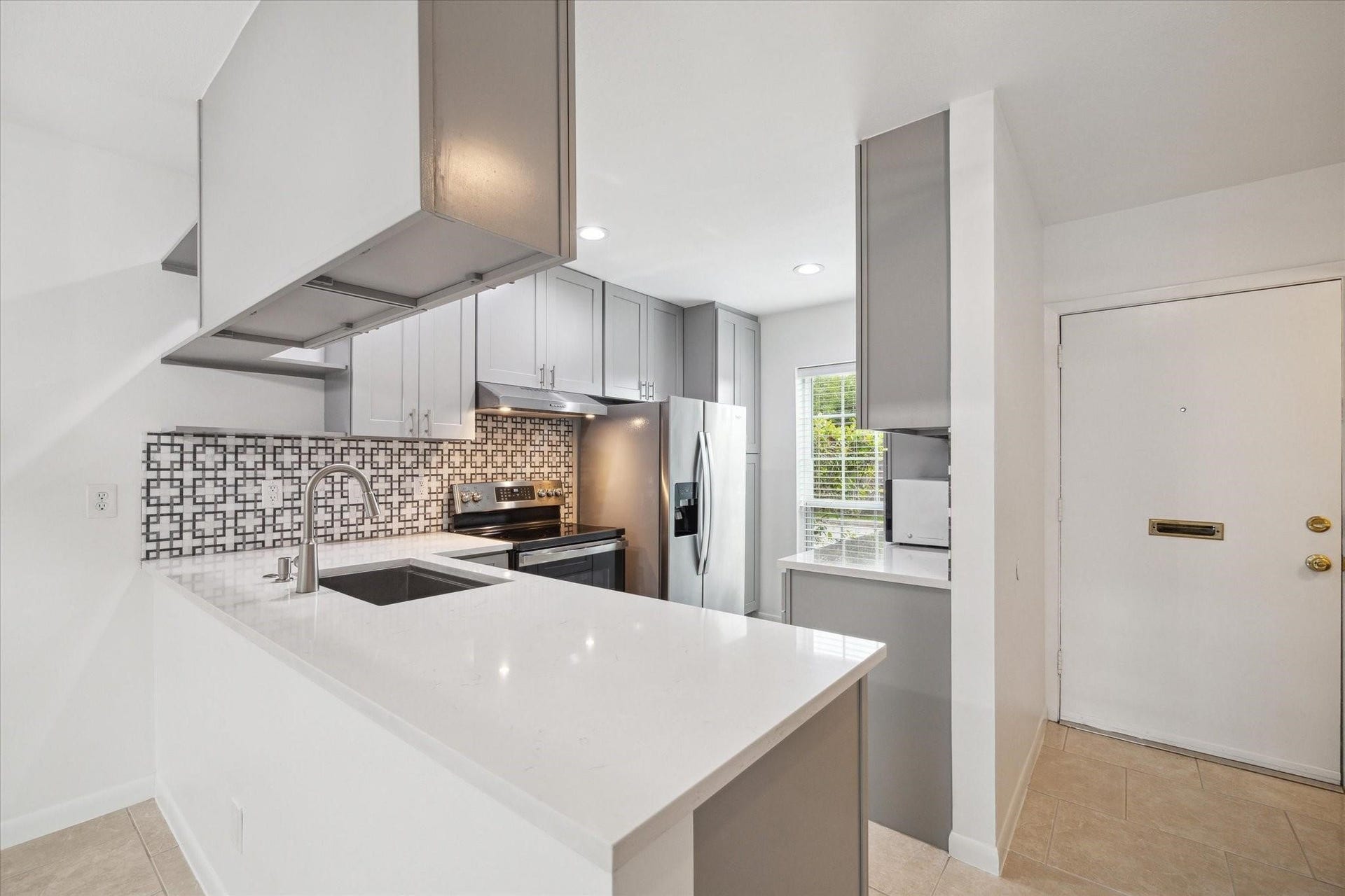 7821 Rue Saint Cyr Street, #55, Houston, TX 77074 Beautifully remodeled kitchen with quartz countertops and modern cabinetry.