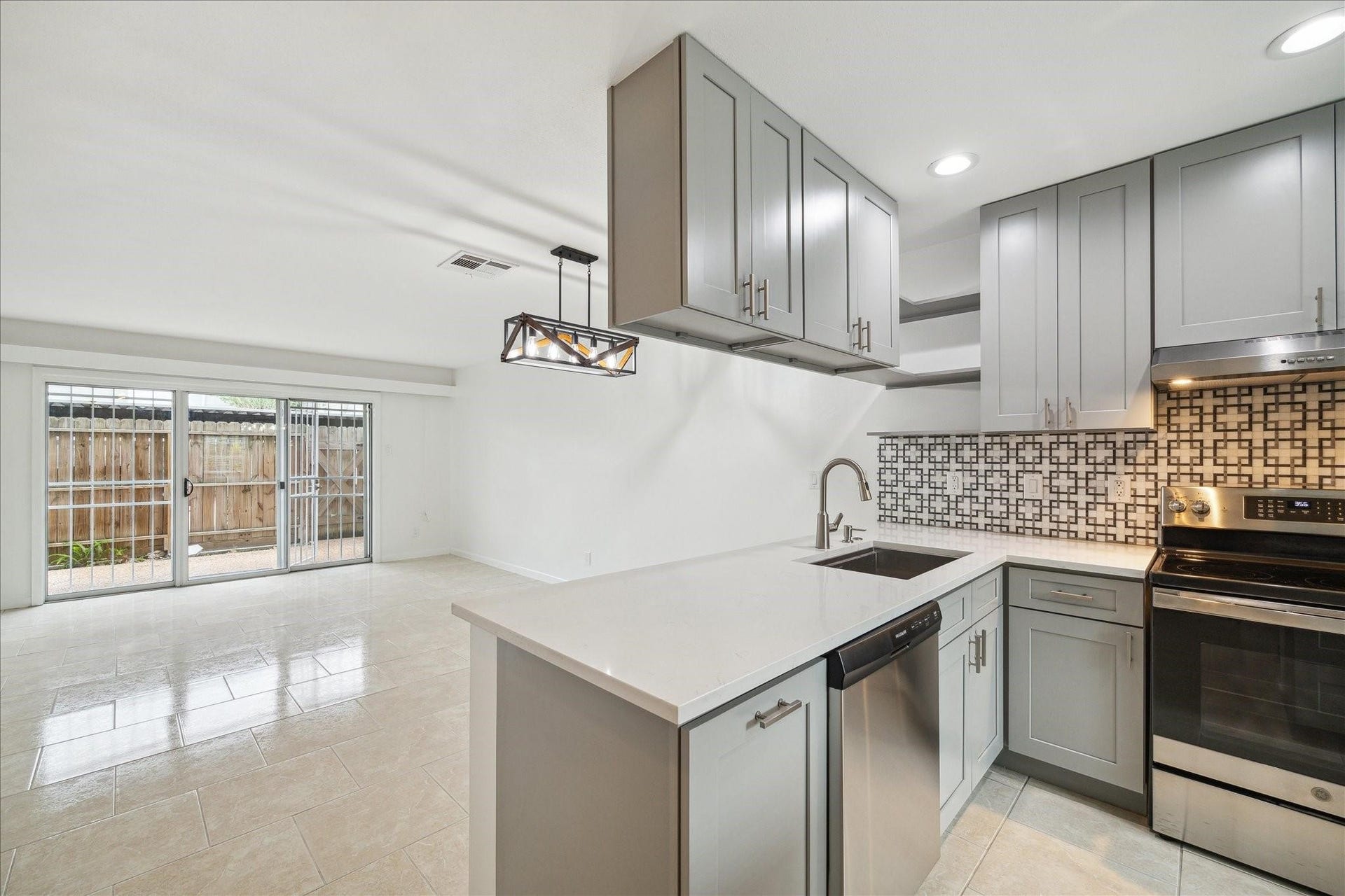 7821 Rue Saint Cyr Street, #55, Houston, TX 77074 Modern kitchen with breakfast bar and stainless steel appliances.