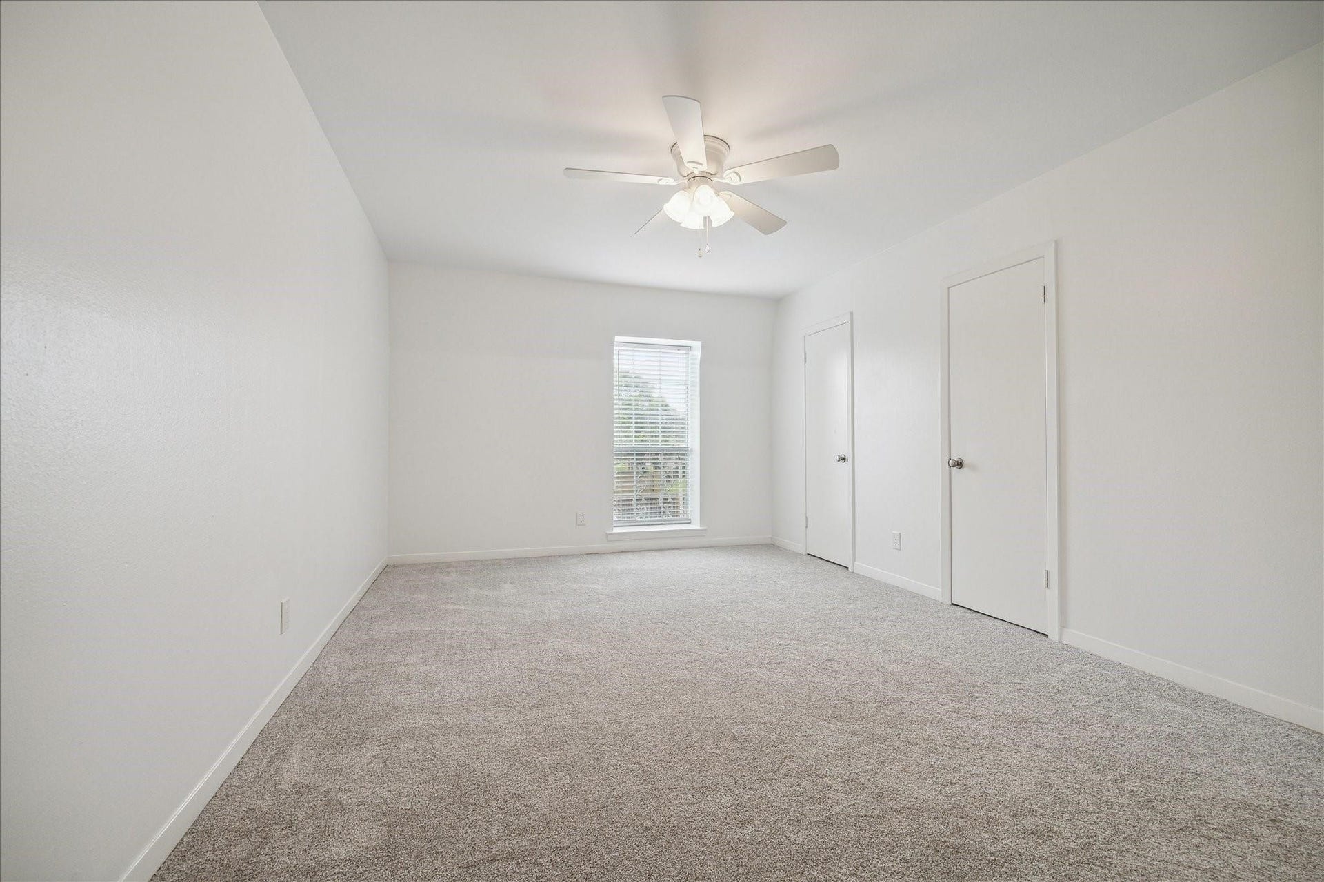 7821 Rue Saint Cyr Street, #55, Houston, TX 77074 Expansive primary bedroom with fresh carpet and abundant natural light.