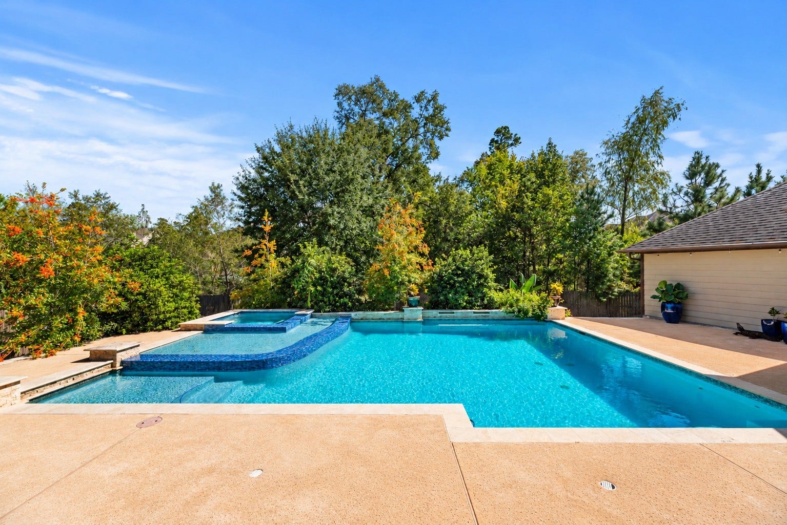 12522 Savage Court, Magnolia, TX 77354 The sparkling resort-style pool with a raised spa, expansive decking, and lush, mature landscaping provides a beautiful, private setting.