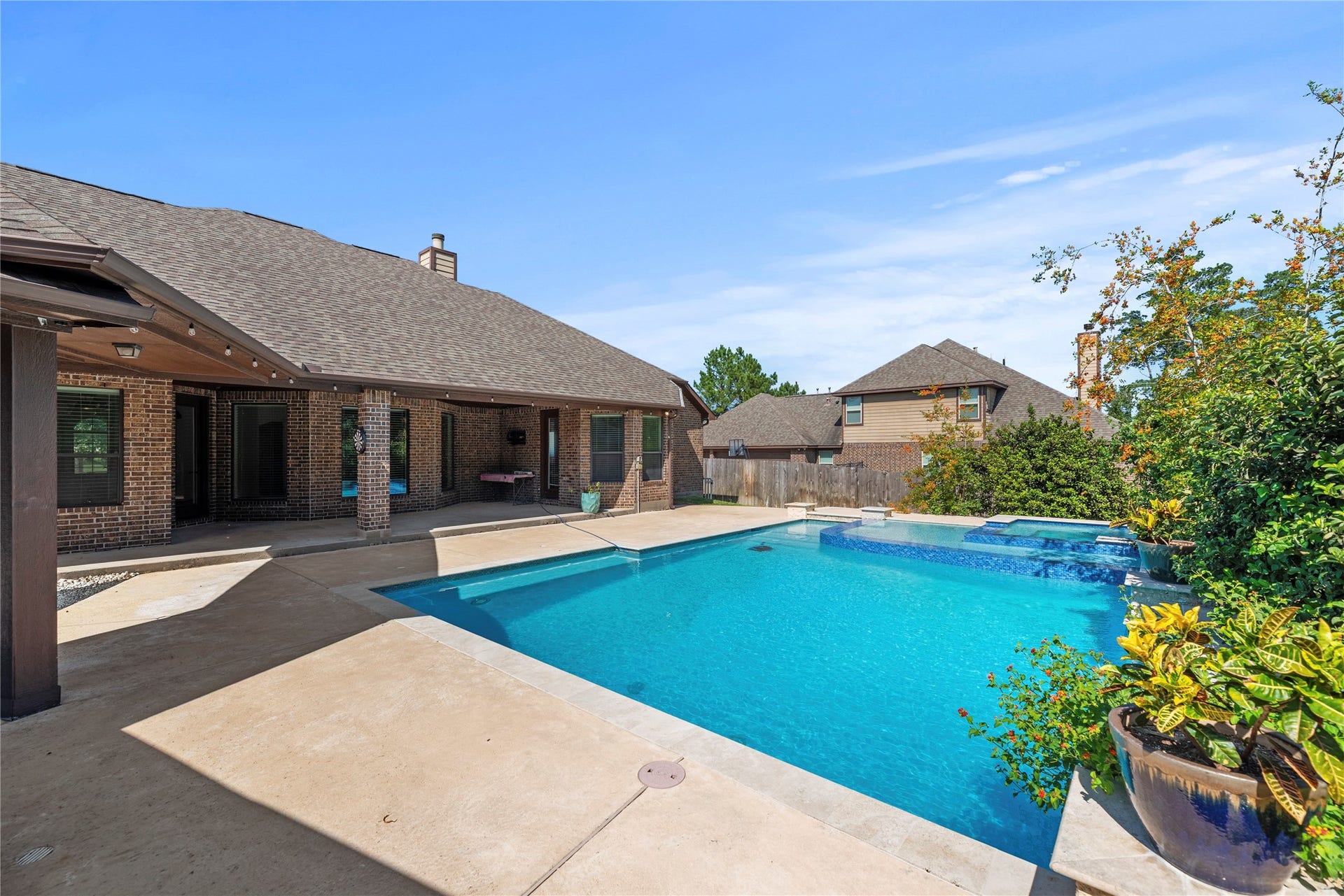 12522 Savage Court, Magnolia, TX 77354 Step outside to an amazing backyard with a refreshing pool/spa and covered patio.