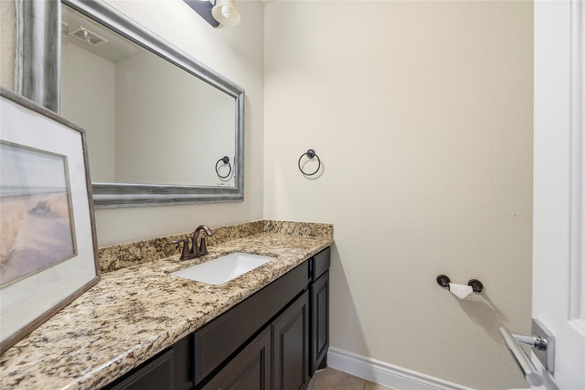 12522 Savage Court, Magnolia, TX 77354 Convenient half bathroom with a granite vanity.