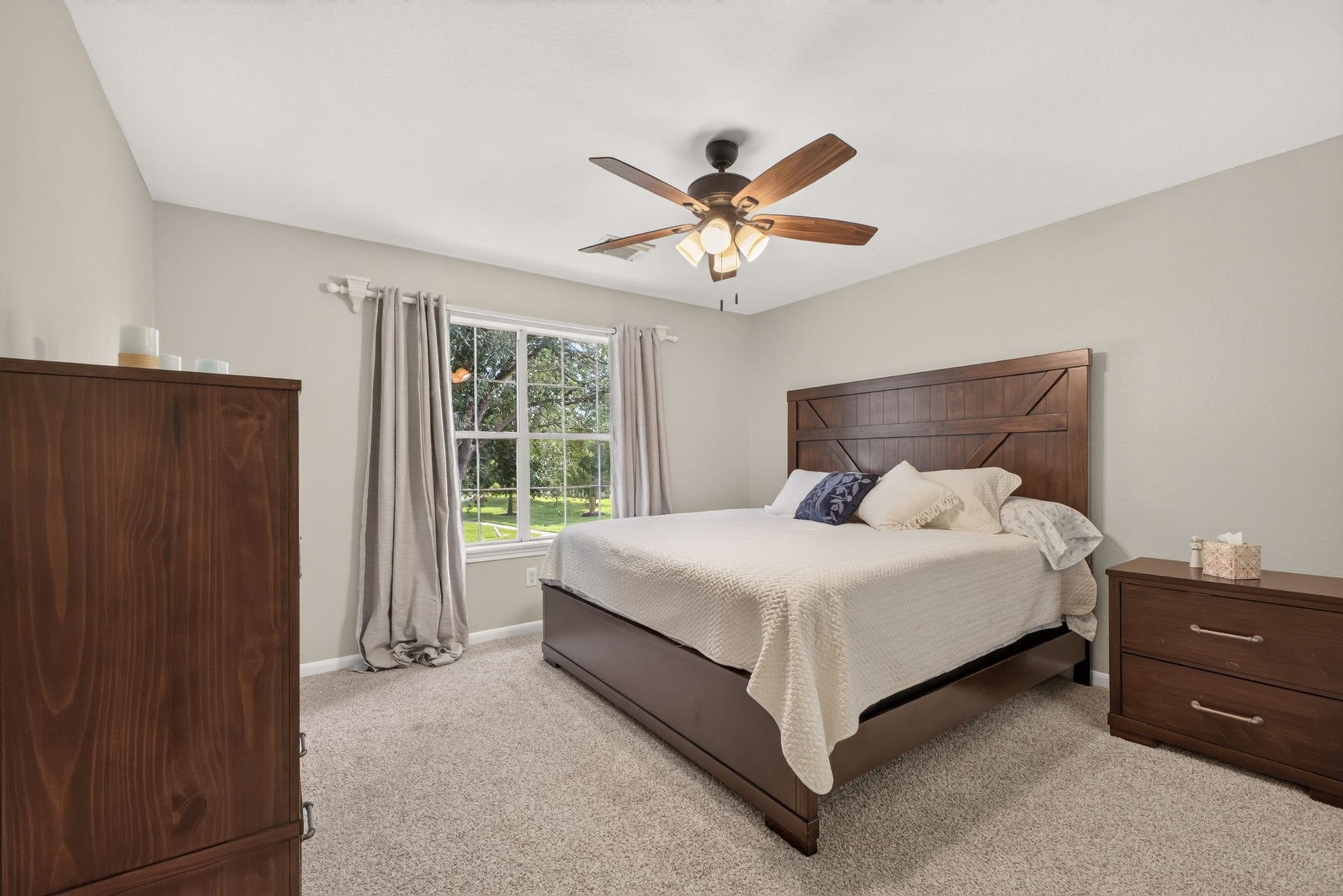 17307 Thicket Hollow Lane, Cypress, TX 77429 Secondary bedroom featuring a large window with a view, neutral walls, and carpeted flooring.