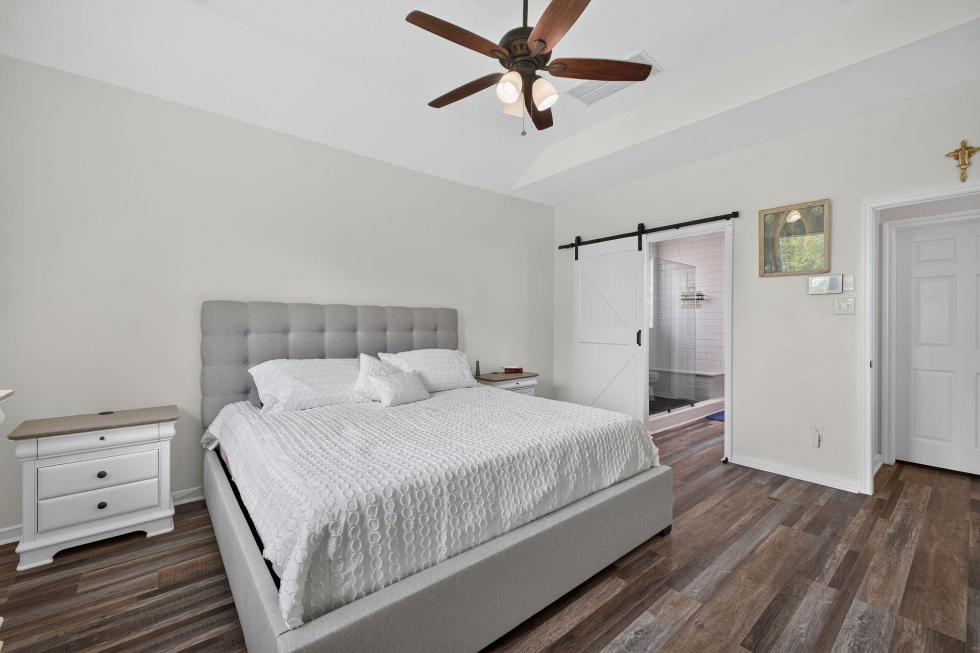 17307 Thicket Hollow Lane, Cypress, TX 77429 Primary bedroom with sliding barn door leading to an ensuite bathroom
