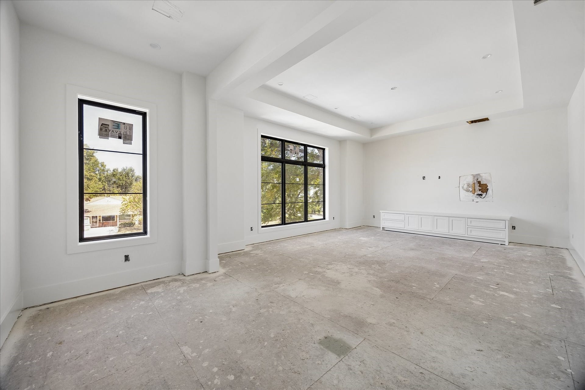 915 Lamonte Lane, Houston, TX 77018 Built in lower cabinetry provides storage along one wall of this upper level room, leaving the center open for flexible use. A broad window, recessed ceiling and substantial trim give the space definition. Flooring, lighting and final fittings remain in progress.