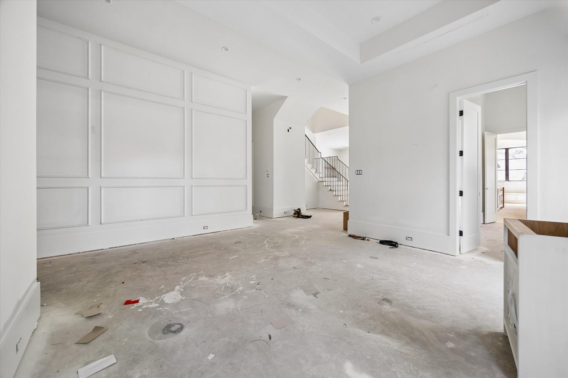 915 Lamonte Lane, Houston, TX 77018 Rectangular wall molding gives the dining room a defined architectural backdrop. A wide opening leads toward the stair hall and adjoining spaces. Builder specifications call for 12 inch downstairs baseboards, adding scale to the trim package beneath the tall ceilings.