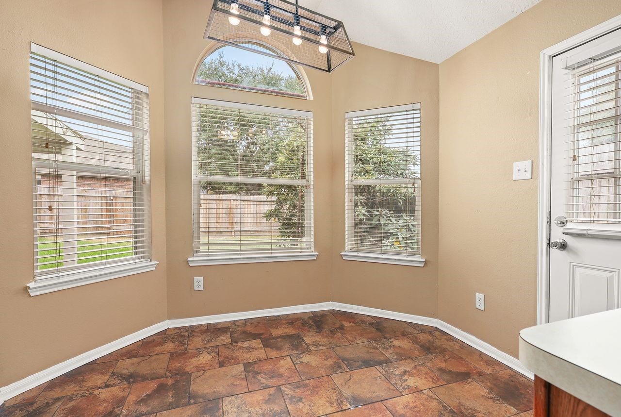 3802 Oakwilde Circle, La Porte, TX 77571 Bright and Cheerful Breakfast Nook Features High Ceiling, Beautiful Arched Window, and Multiple Windows Overlooking the Backyard.