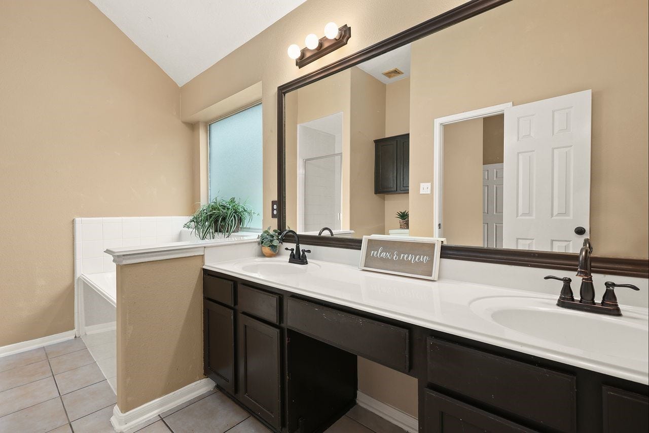 3802 Oakwilde Circle, La Porte, TX 77571 Another View of the Primary Bath Showcasing the Spacious Dual-Sink Vanity, Generous Counter Space, and Relaxing Jetted Tub.