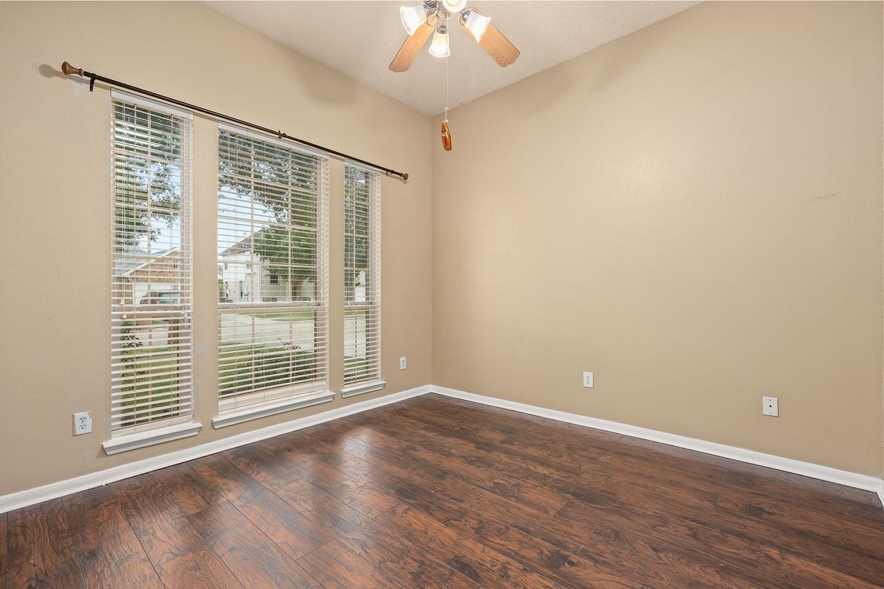 3802 Oakwilde Circle, La Porte, TX 77571 Another Nicely Sized Secondary Bedroom with Beautiful Wood-Look Flooring, Ceiling Fan, and Large Windows Overlooking the Front Yard.