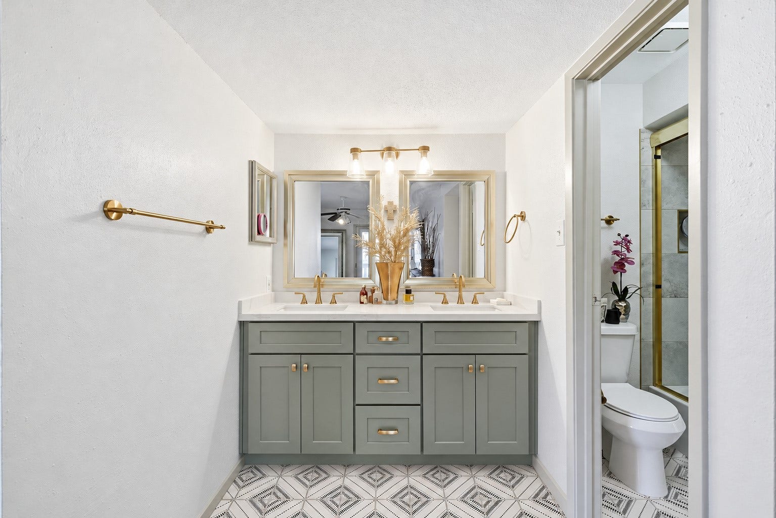 Completely remodeled primary bathroom with dual sinks, quartz countertops, and designer tile.