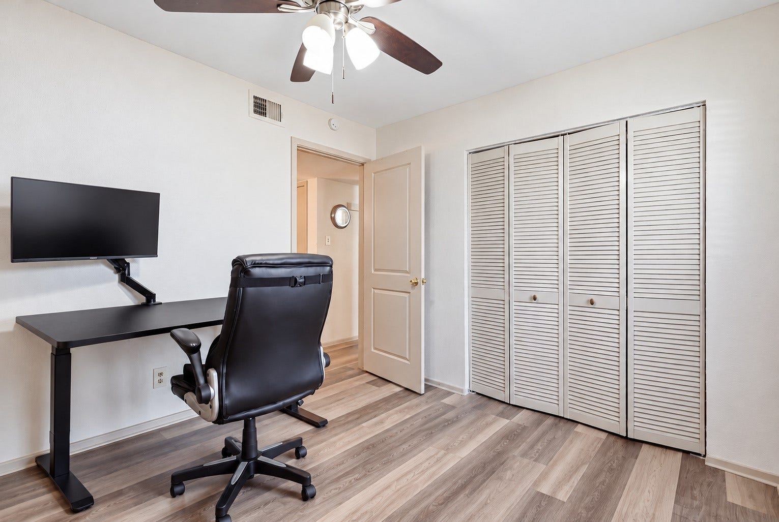 Versatile second bedroom offers space for guests, a home office or personal use.
