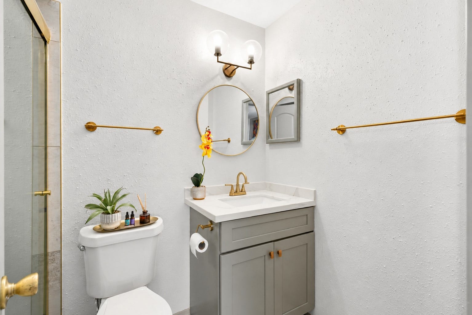 Secondary bathroom with modern gold accents that compliment the home's overall design.