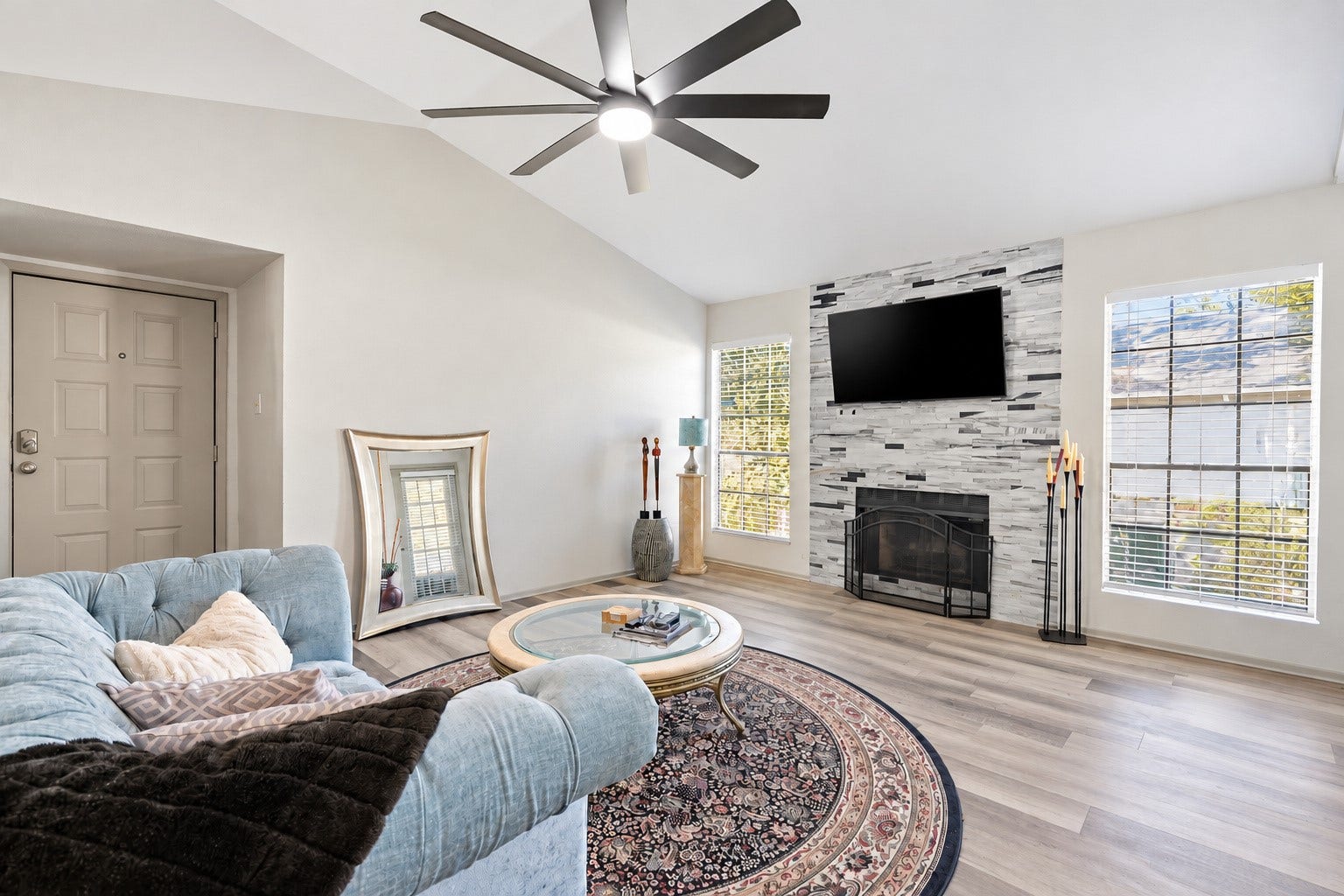 Welcome to a bright and inviting living area featuring a wood burning fireplace and space to entertain.