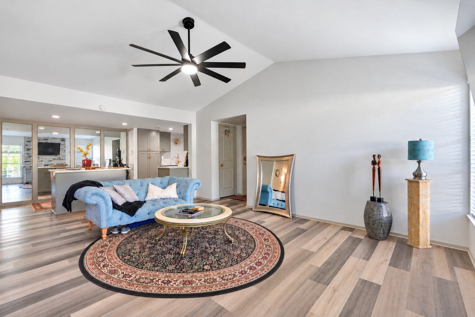 Spacious living area with an open layout connecting the living, dining and kitchen spaces.