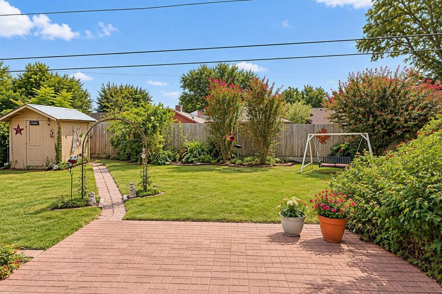 6631 Inwood West Drive, Houston, TX 77088 Lush backyard gardens with storage shed and exterior sitting area