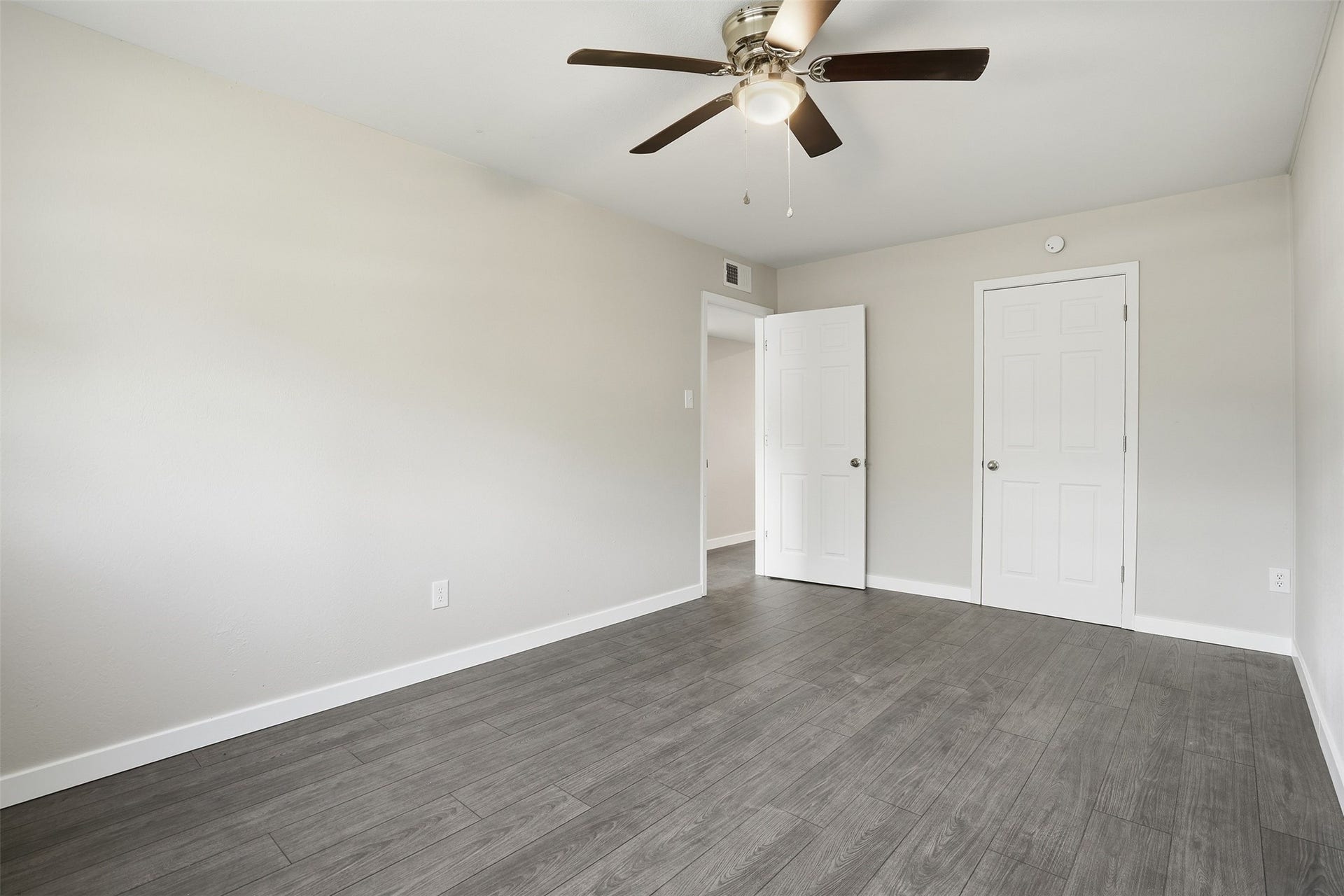 Spacious primary bedroom with ample natural light and a comfortable layout.