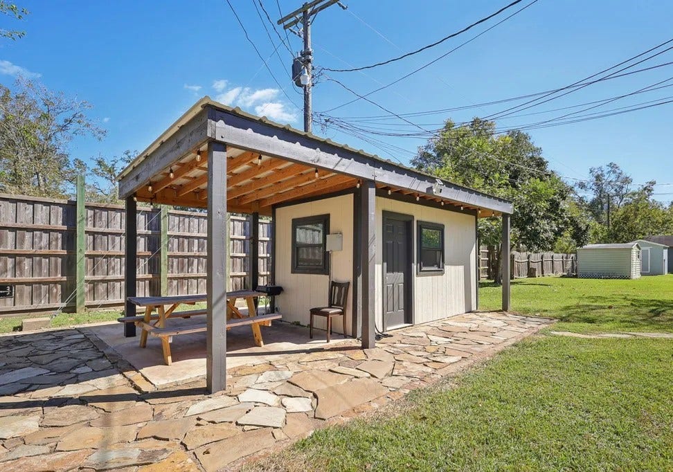 A cozy outdoor bench is thoughtfully placed on the patio, offering a perfect spot to relax and enjoy the fresh air.