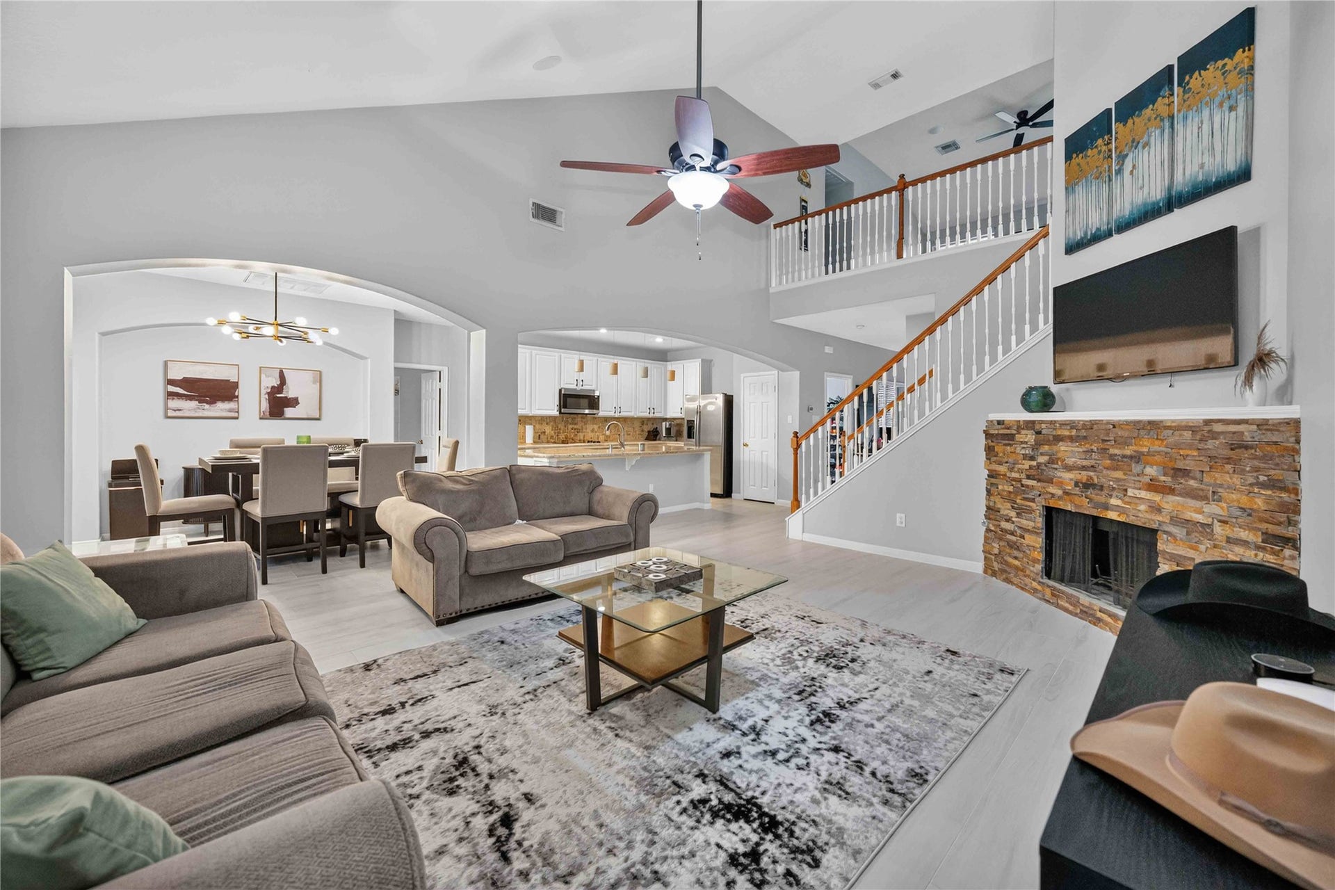 Wide view of the living room, dining room, and kitchen