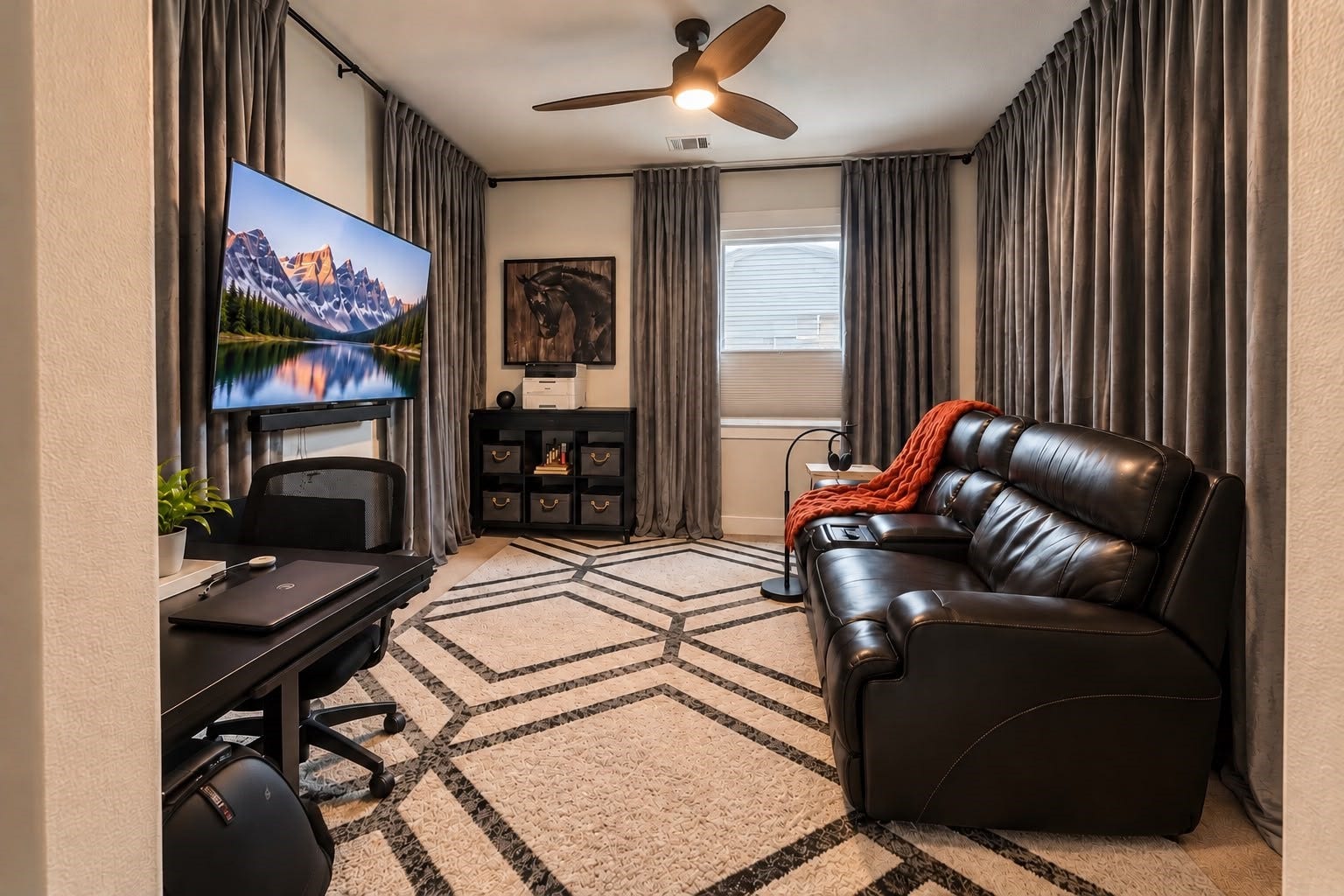 413 Forest Reserve Place, Houston, TX 77079 Private media room featuring a large television, comfortable leather seating, full-length curtains, and a geometric-patterned area rug.