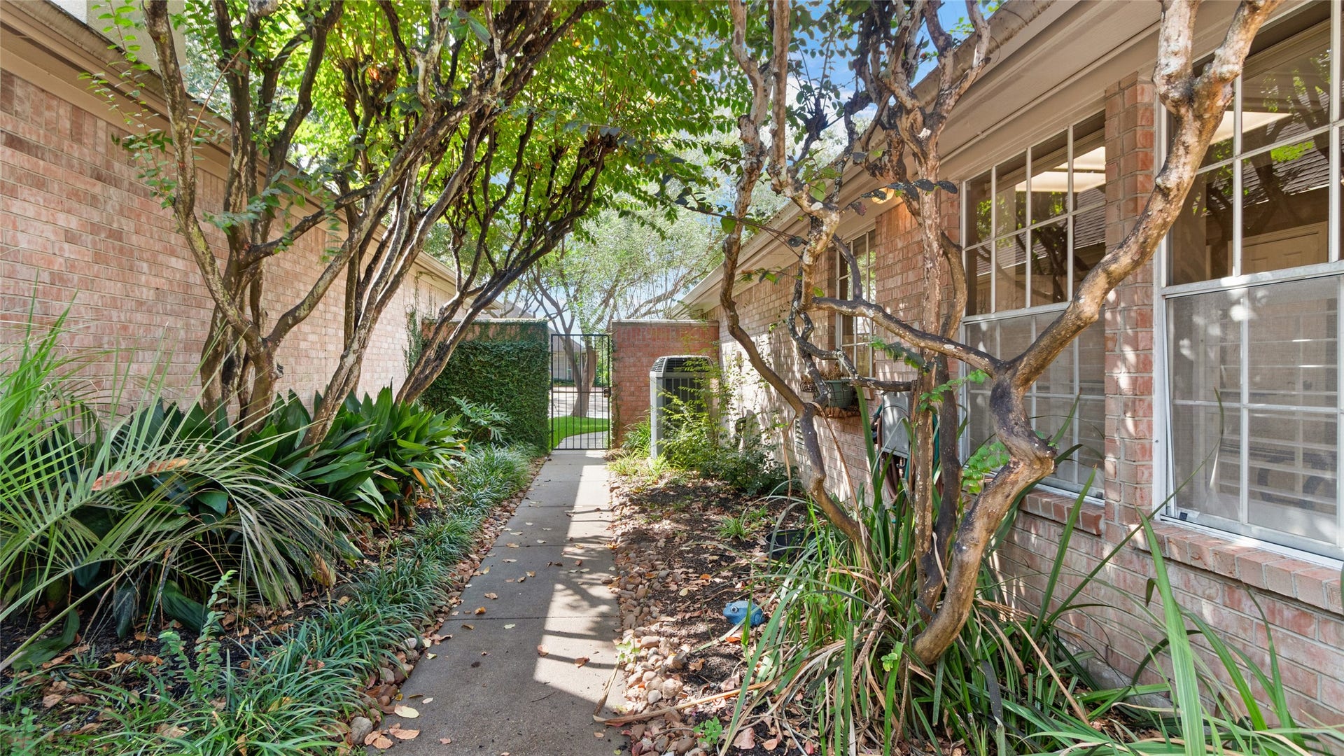 2430 Fairway Pointe Drive, League City, TX 77573 Beautifully landscaped backyard with a charming garden entryway.