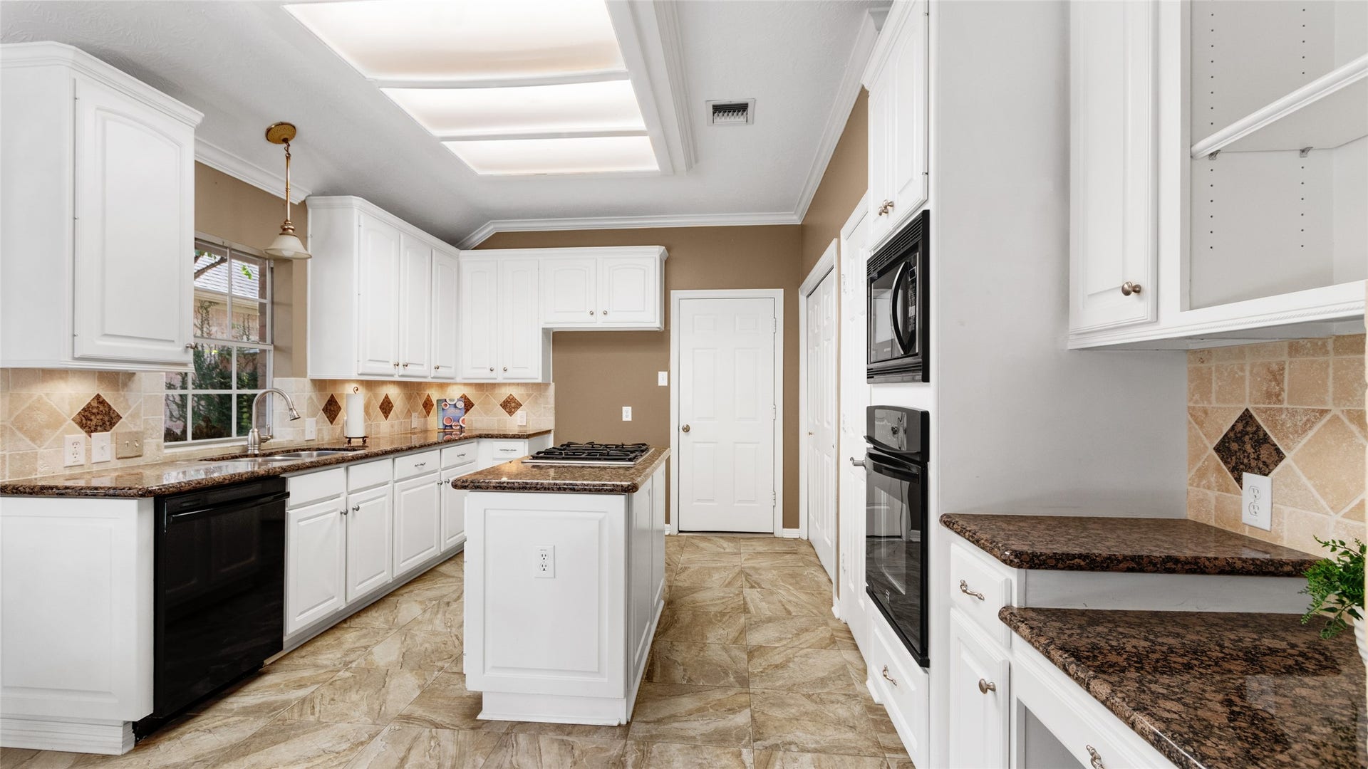 2430 Fairway Pointe Drive, League City, TX 77573 Kitchen offers granite counter tops and island with cooktop.