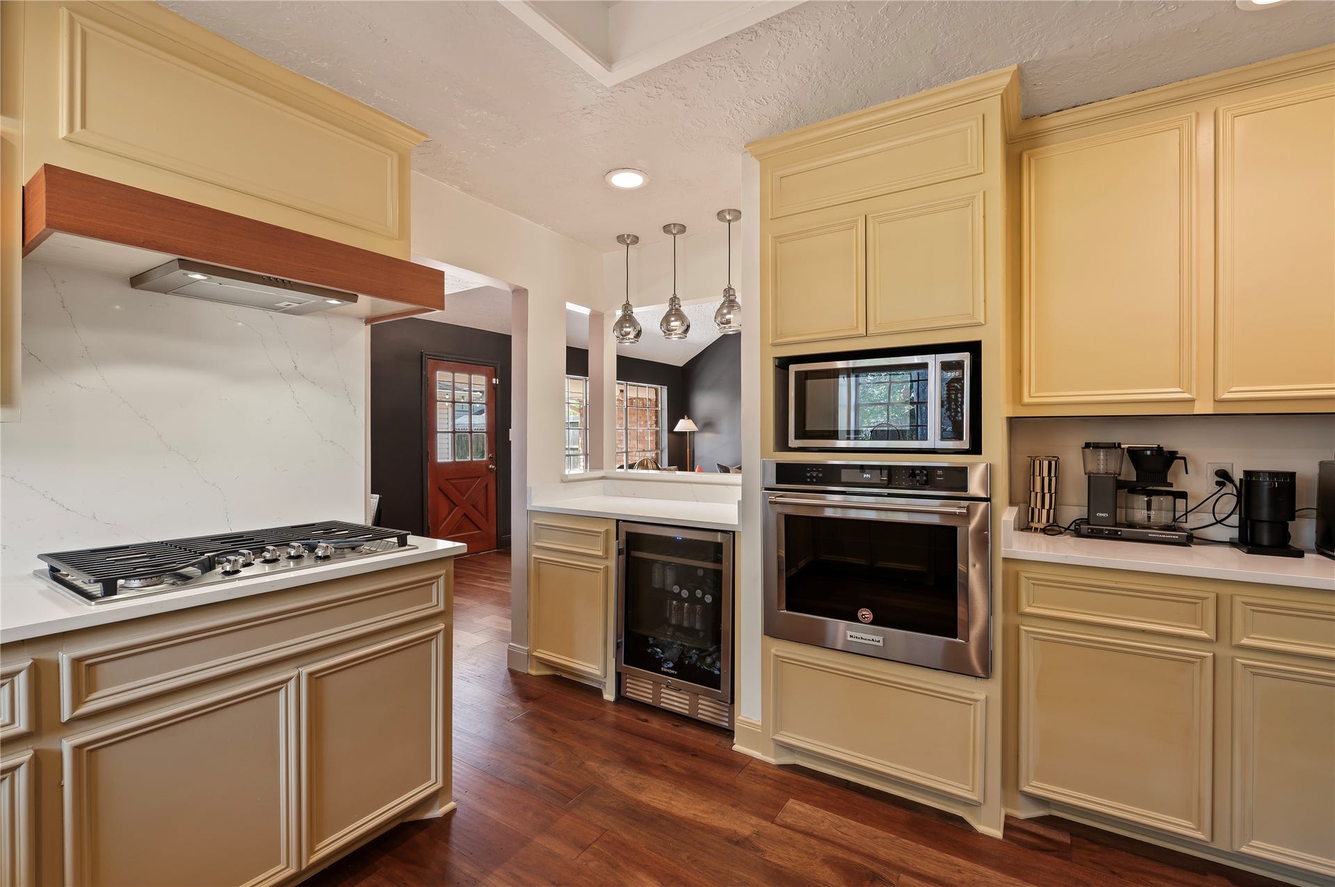 501 Audubon Street, League City, TX 77573 Built in stainless steel oven and microwave near the bar area with built in wine fridge.