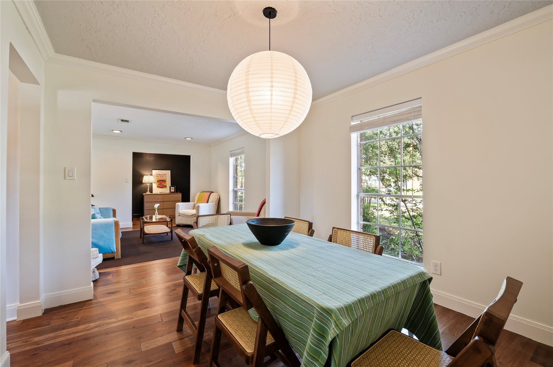 501 Audubon Street, League City, TX 77573 Spacious formal dining with wood like flooring, hanging light fixture and front yard views.